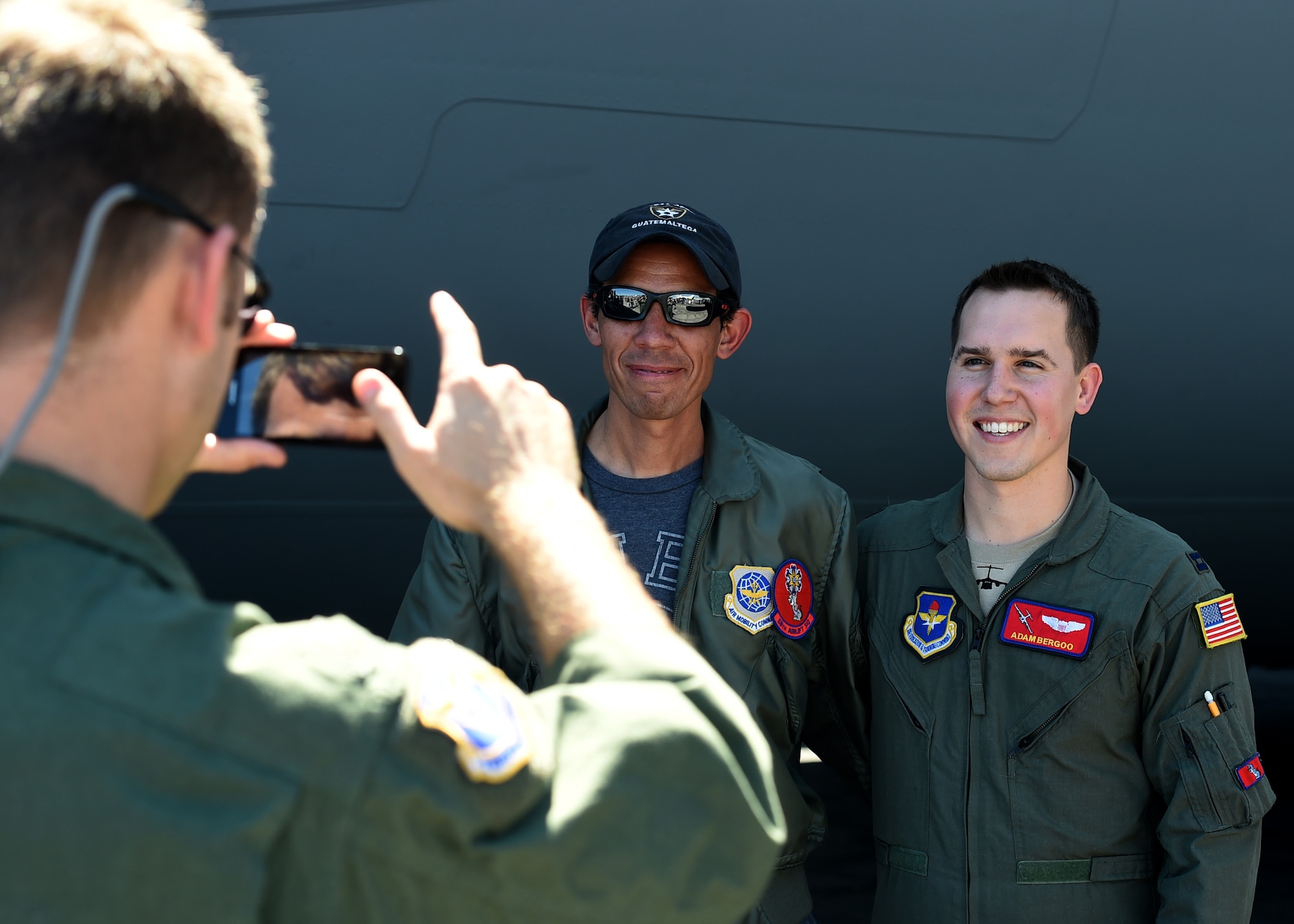 A citizen from El Salvador, has a photo taken with U.S. Air Force Capt. Adam Bergoo, 58th Airlift Squadron instructor pilot, at Ilopango International Airport in San Salvador, El Savador, Jan. 30, during the 2016 Ilopango Airshow. A U.S. Air Force C-17 Globemaster III cargo aircraft was sent from Altus Air Force Base, Okla., to foster relationships between the U.S. and El Salvador. The aircraft was setup as a static display for the natives to view and learn about some of its capabilities. (U.S. Air Force photo by Senior Airman Franklin R. Ramos/Released)
