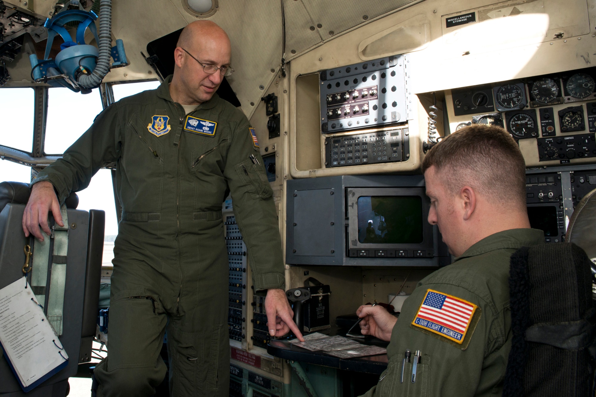 U.S. Air Force Reserve Senior Master Sgt. Duane Moore and Master Sgt. Dave Hemphill, discuss takeoff and landing data prior to the last training mission flight of a C-130H assigned to the 913th Airlift Group at Little Rock Air Force Base, Ark., Jan. 28, 2016. The final two-hour mission consisted of low level air drop techniques and pilot proficiency training. Both Airmen are flight engineers assigned to the 327th Airlift Squadron at Little Rock AFB. (U.S. Air Force photo by Master Sgt. Jeff Walston/Released)