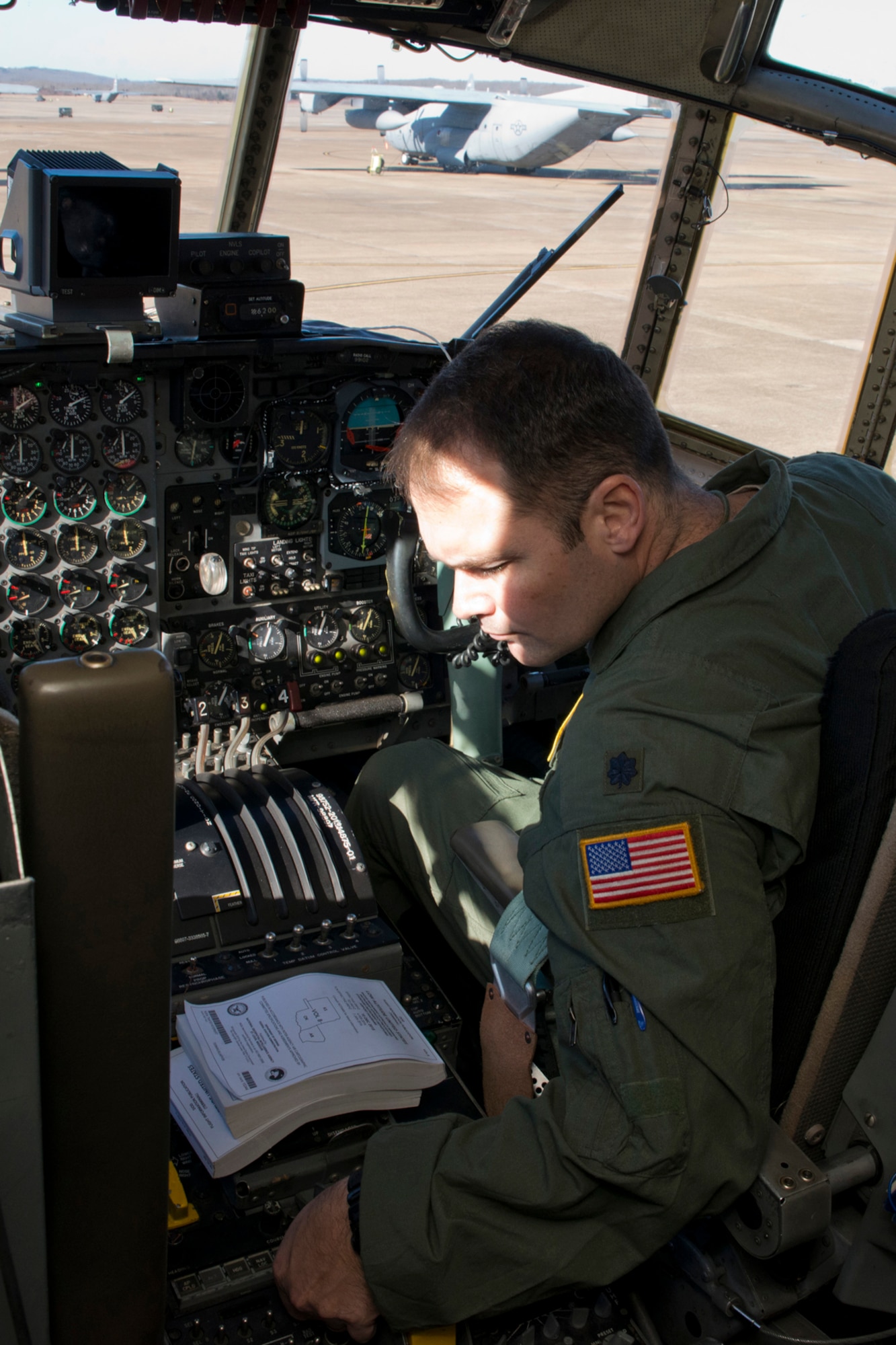 U.S. Air Force Reserve Lt. Col. Keith Jasmin, chief of current operations, 913th Operations Support Squadron, performs preflight checklist before a training mission at Little Rock Air Force Base, Ark., Jan. 28, 2016. The final two-hour mission consisted of low level air drop techniques and pilot proficiency training. (U.S. Air Force photo by Master Sgt. Jeff Walston/Released)  
