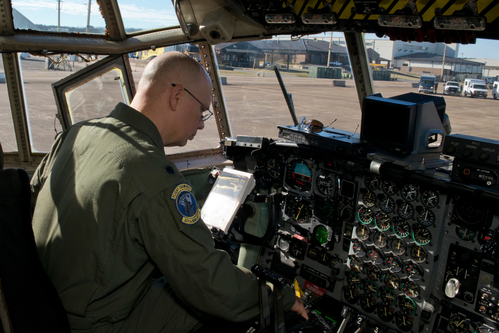 U.S. Air Force Reserve Lt. Col. Neil Hede, commander of the 327th Airlift Squadron, performs preflight checklist before a training mission at Little Rock Air Force Base, Ark., Jan. 28, 2016. The final two-hour mission consisted of low level air drop techniques and pilot proficiency training. (U.S. Air Force photo by Master Sgt. Jeff Walston/Released)   