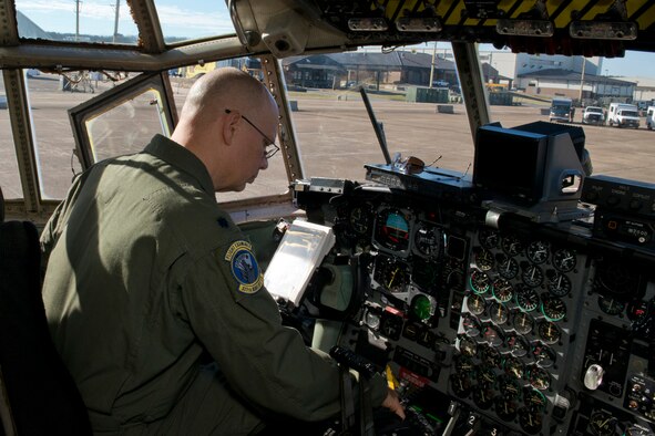 U.S. Air Force Reserve Lt. Col. Neil Hede, commander of the 327th Airlift Squadron, performs preflight checklist before a training mission at Little Rock Air Force Base, Ark., Jan. 28, 2016. The final two-hour mission consisted of low level air drop techniques and pilot proficiency training. (U.S. Air Force photo by Master Sgt. Jeff Walston/Released)   