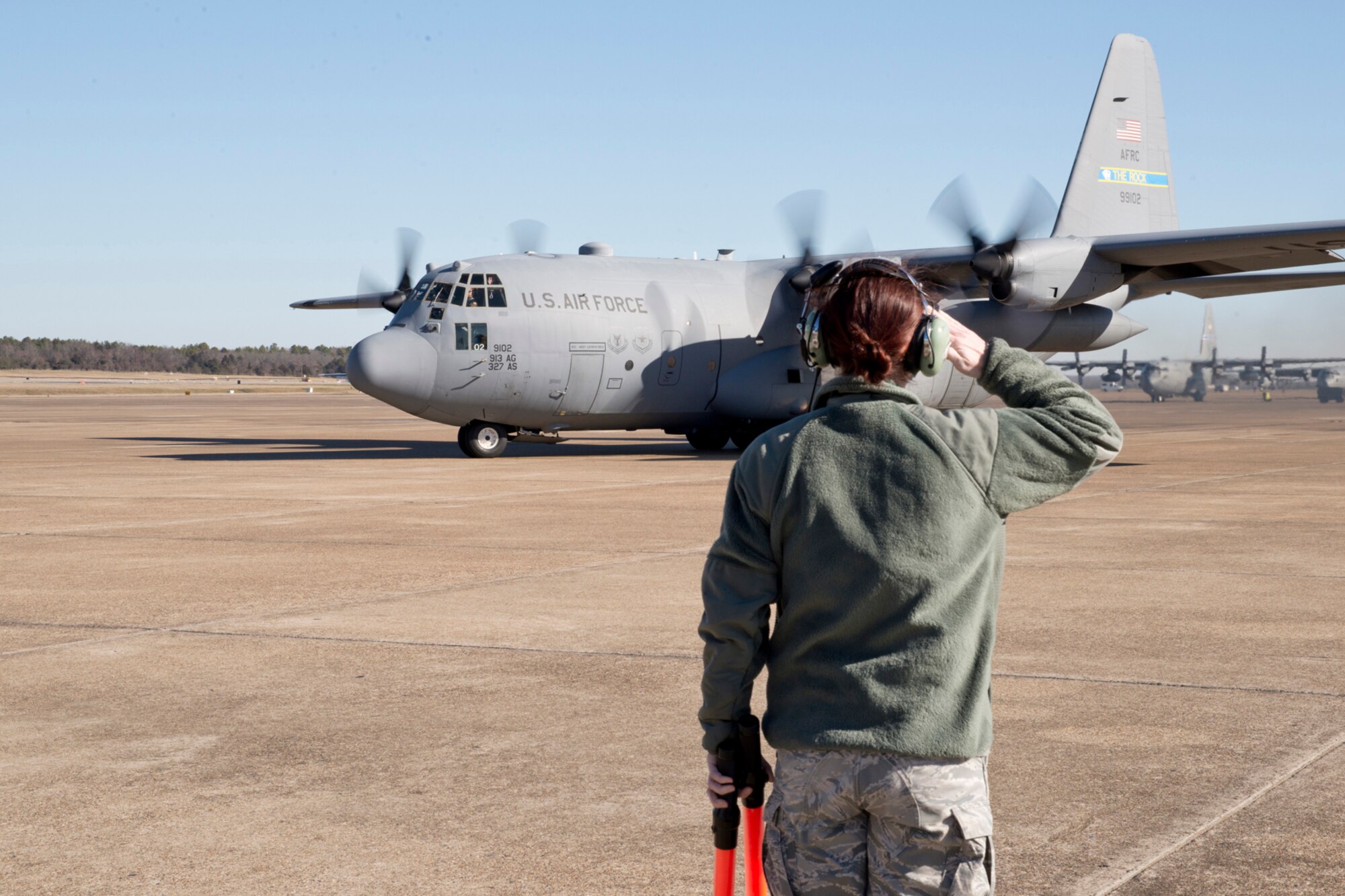 U.S. Air Force Reserve Master Sgt. Cathryn Rock, a dedicated crew chief assigned to the 913th Maintenance Squadron, salutes as her aircraft taxis to the runway for its last training mission takeoff from Little Rock Air Force Base, Ark., Jan. 28, 2016. The aircraft will be transferred to a new location, as part of the group’s transition from the “H” model to the “J” model. (U.S. Air Force photo by Master Sgt. Jeff Walston/Released)