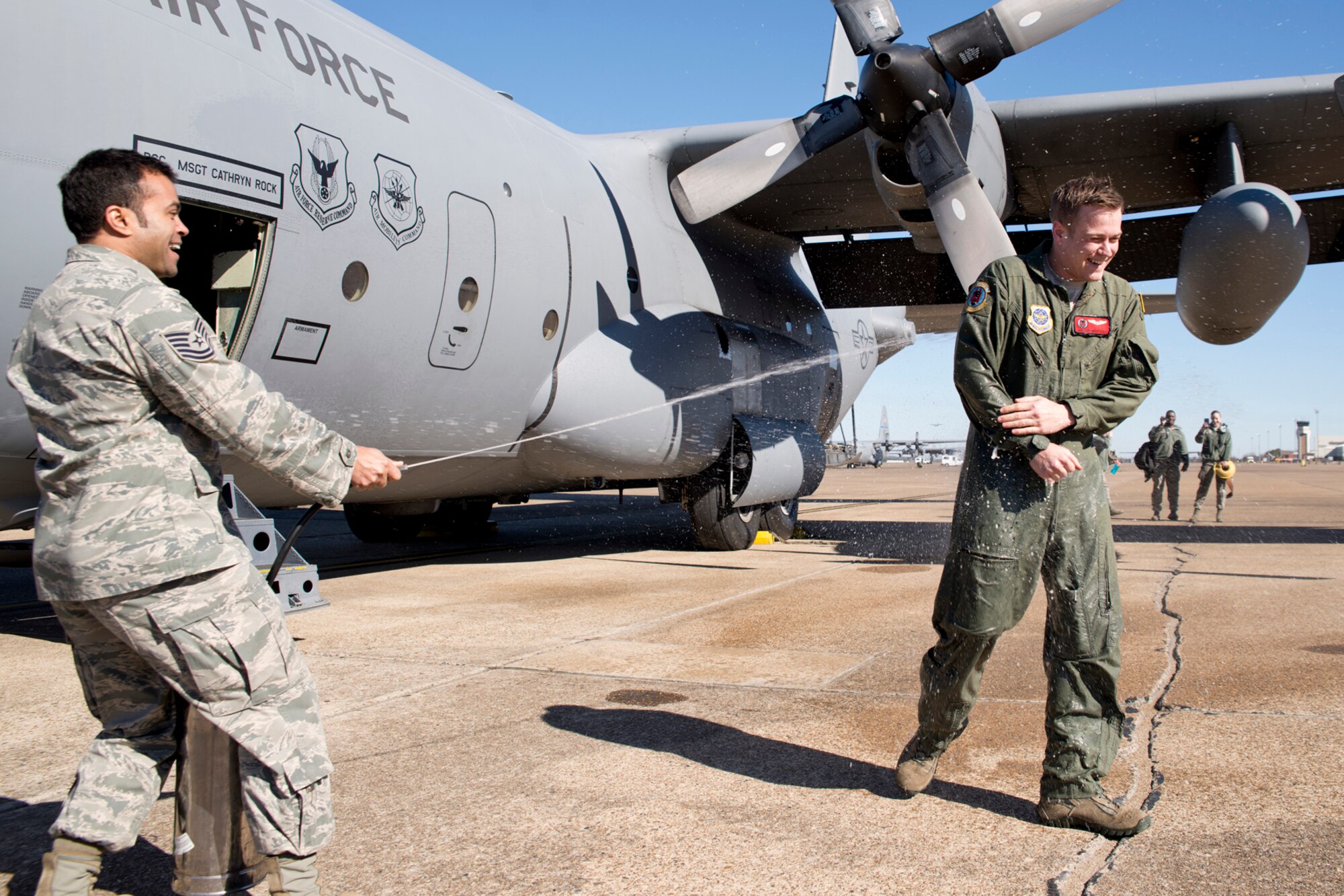 U.S. Air Force Senior Airman Cody Greathouse, a loadmaster assigned to the 50th Airlift Squadron, gets sprayed down by Tech. Sgt. Bobby McMillian, 50 AS, after his fini-flight in a C-130H at Little Rock Air Force Base, Ark., Jan. 28, 2016.  Greathouse was a member of the aircrew on board the last training mission flight in a C-130H for the 913th Airlift Group, which marked the end of his time in the Air Force at Little Rock AFB. (U.S. Air Force photo by Master Sgt. Jeff Walston/Released)