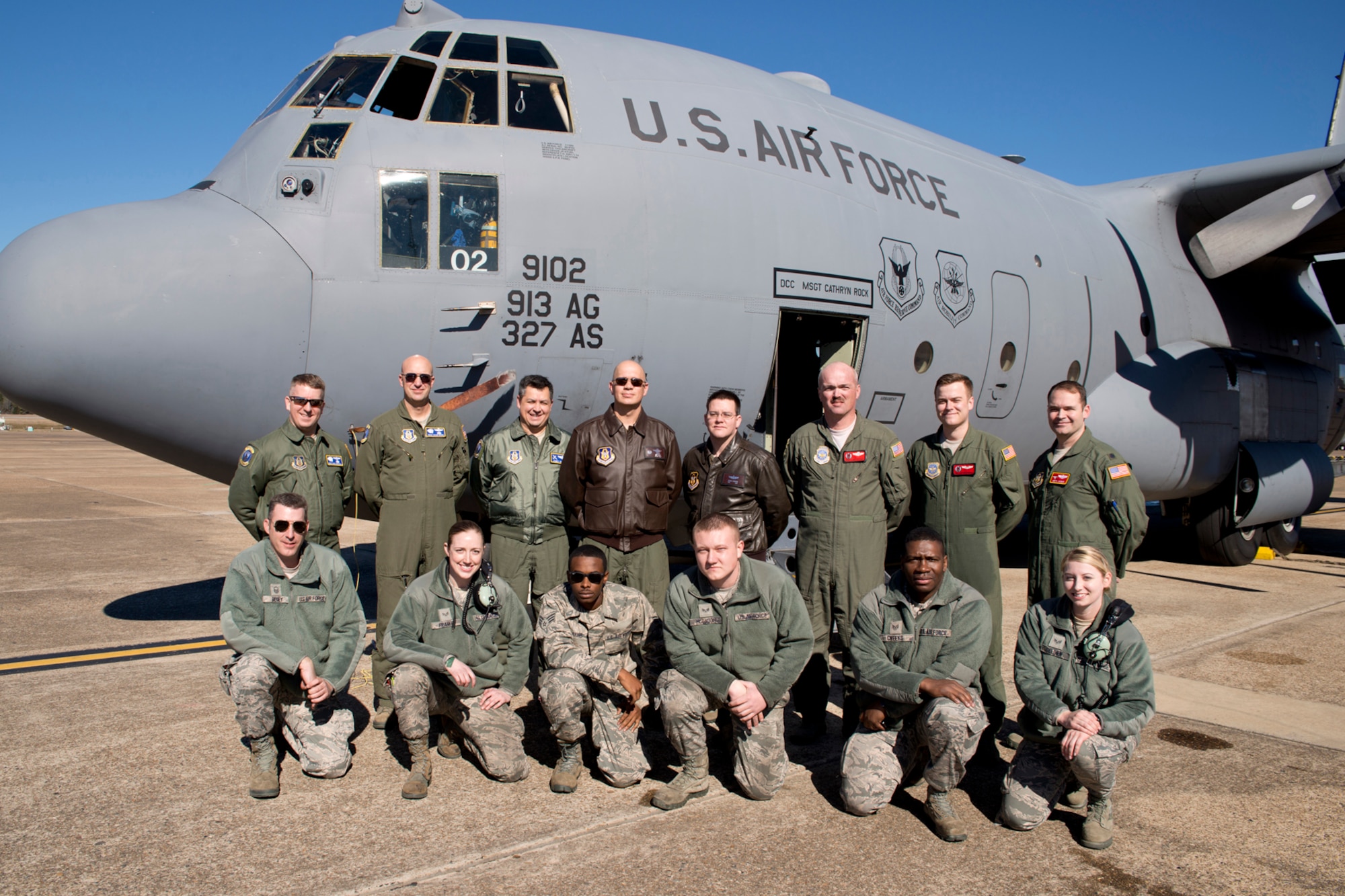 U.S. Air Force aircrew members and passengers of the last training mission flight in a C-130H for the 913th Airlift Group, pose for a photo after the flight at Little Rock Air Force Base, Ark., Jan. 28, 2016. (Standing L-R) U.S. Air Force Master Sgt. Dave Hemphill, flight engineer, Senior Master Sgt. Duane Moore, flight engineer, Lt. Col. James Trevino, navigator, Lt. Col. Neil Hede, pilot, Tech. Sgt. Derek Johnson, loadmaster, Master Sgt. James Cope, loadmaster, Senior Airman Cody Greathouse, loadmaster, and Lt. Col. Keith Jasmin, pilot, (Kneeling L-R) Master Sgt. Geoff Begey, expeditor, Senior Airman Jennifer Franke, crew chief, Senior Airman Kquamae Akins, crew chief, Senior Airman Dawton McGaugh, crew chief, Staff Sgt. Bryan Cheeks, engine mechanic and Senior Airman Ariel Geldien, electronic environmental technician. (U.S. Air Force photo by Master Sgt. Jeff Walston/Released)