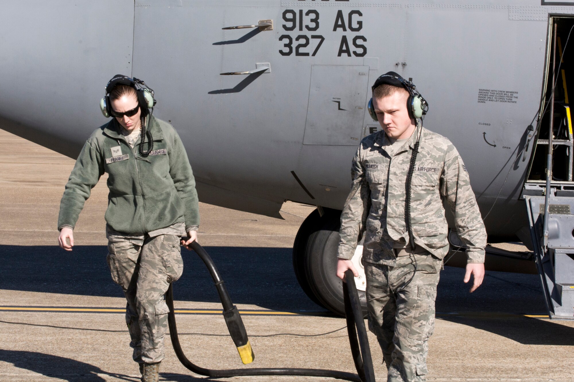 U.S. Air Force Reserve Senior Airmen Jennifer Franke and Dawton McGaugh, remove a power cart connection from a C-130H Hercules before it flies its final training mission at Little Rock Air Force Base, Ark, Jan. 28, 2016. Both Airmen are crew chiefs assigned to the 913th Maintenance Squadron, and were allowed to ride on the final training mission for the 913th Airlift Group in its transition from the C-130 “H” model to the newer “J” model. (U.S. Air Force photo by Master Sgt. Jeff Walston/Released)   