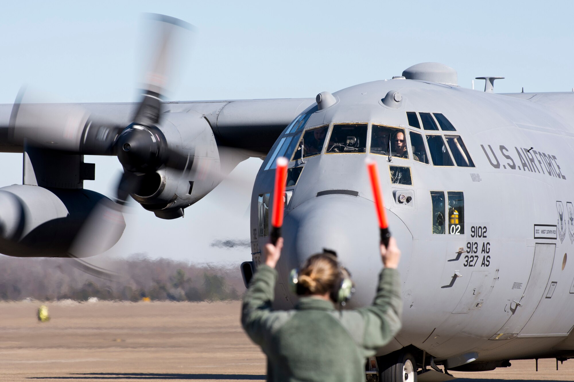 U.S. Air Force Reserve Tech. Sgt. Stephanie Martin, engine mechanic, 913th Maintenance Squadron, marshals a C-130H Hercules after its final training mission at Little Rock Air Force Base, Ark., Jan. 28, 2016. The aircraft is one of the last two H models that will soon be transferred to a new locations as part of the group’s conversion from the “H” model to the “J” model. (U.S. Air Force photo by Master Sgt. Jeff Walston/Released)