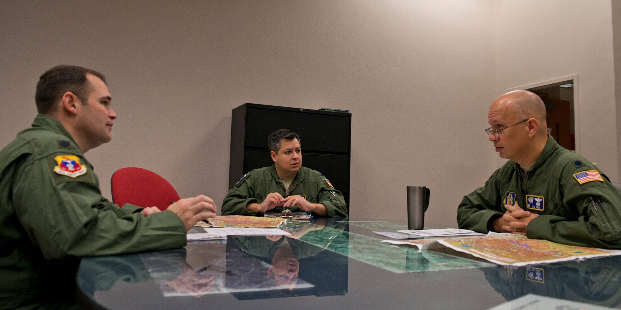 (L-R) U.S. Air Force Reserve Lt. Cols. Keith Jasmin, pilot, James Trevino, navigator and Neil Hede, pilot, conduct a pre-mission briefing prior to the last training mission flight of a C-130H assigned to the 913th Airlift Group at Little Rock Air Force Base, Ark., Jan. 28, 2016. The final two-hour mission consisted of low level air drop techniques and pilot proficiency training. (U.S. Air Force photo by Master Sgt. Jeff Walston/Released)
