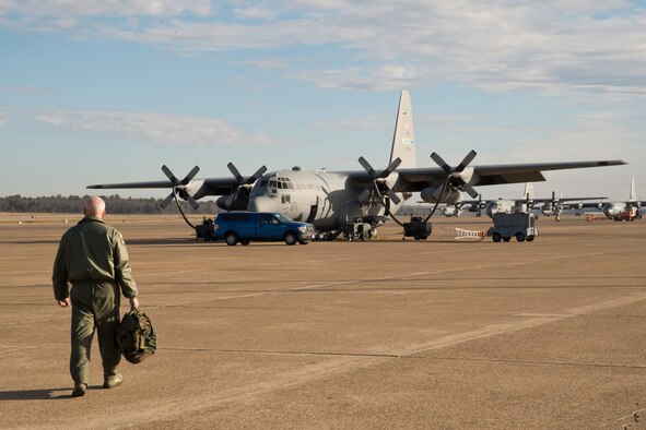 U.S. Air Force Master Sgt. James Cope, a loadmaster assigned to the 50th Airlift Squadron, takes the long walk to a C-130H Hercules for its final training mission flight at Little Rock Air Force Base, Ark., Jan. 28, 2016. Airmen from the 50 AS have worked closely with members of the 913th Airlift Group as part of a Total Force Integration (TFI) active association at Little Rock AFB. Several members of the 50 AS were given the opportunity to take the final flight together as a team. (U.S. Air Force photo by Master Sgt. Jeff Walston/Released)