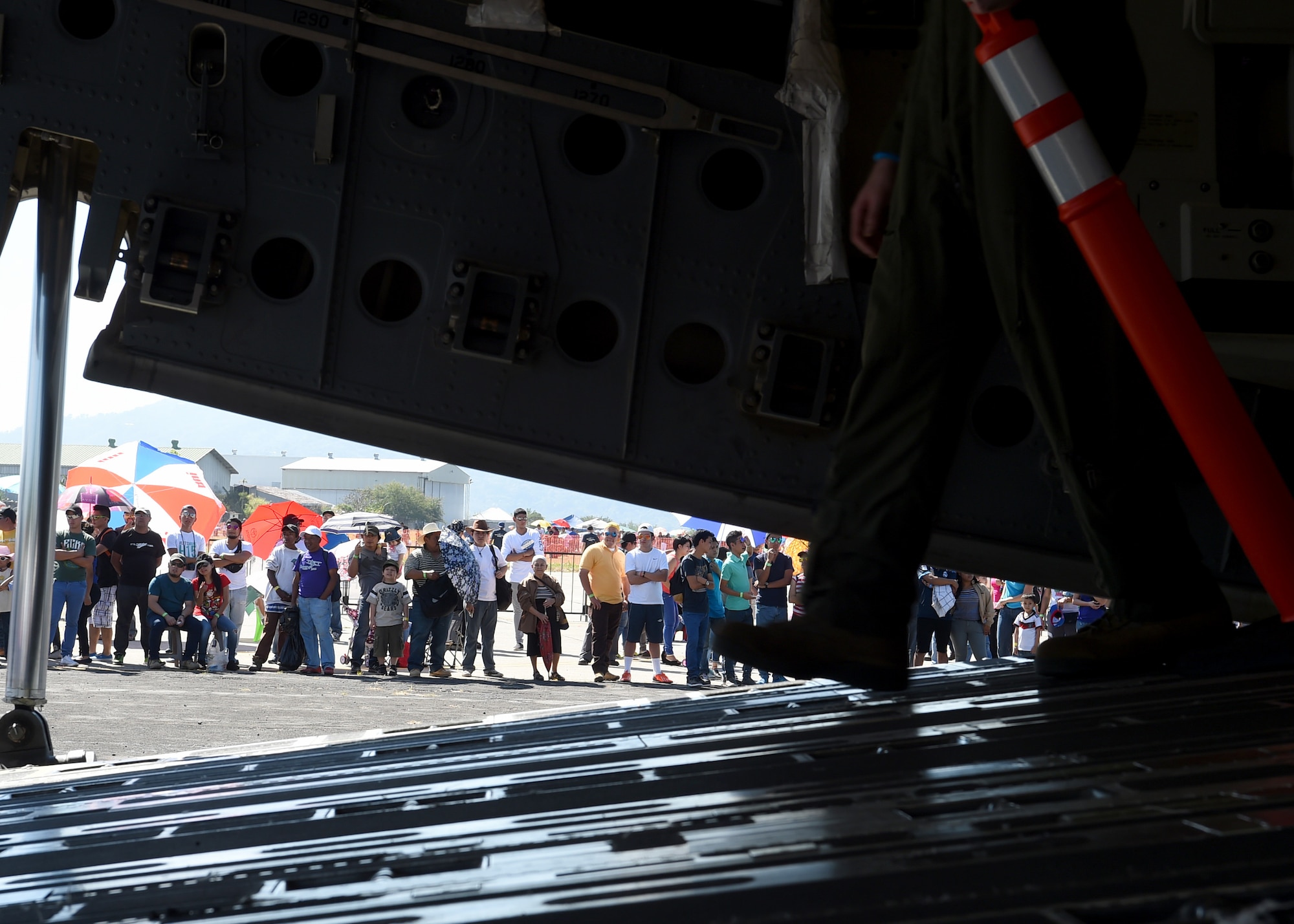 Citizens of El Salvador wait in line to enter a U.S. Air Force C-17 Globemaster III cargo aircraft, 58th Airlift Squadron at Ilopango International Airport in San Salvador, El Savador, Jan. 31, during the 2016 Ilopango Airshow. The C-17 was sent from Altus Air Force Base, Okla., to foster relationships between the U.S. and El Salvador. The aircraft was setup as a static display for the attendees to view and learn about some of its capabilities. (U.S. Air Force photo by Senior Airman Franklin R. Ramos/Released)