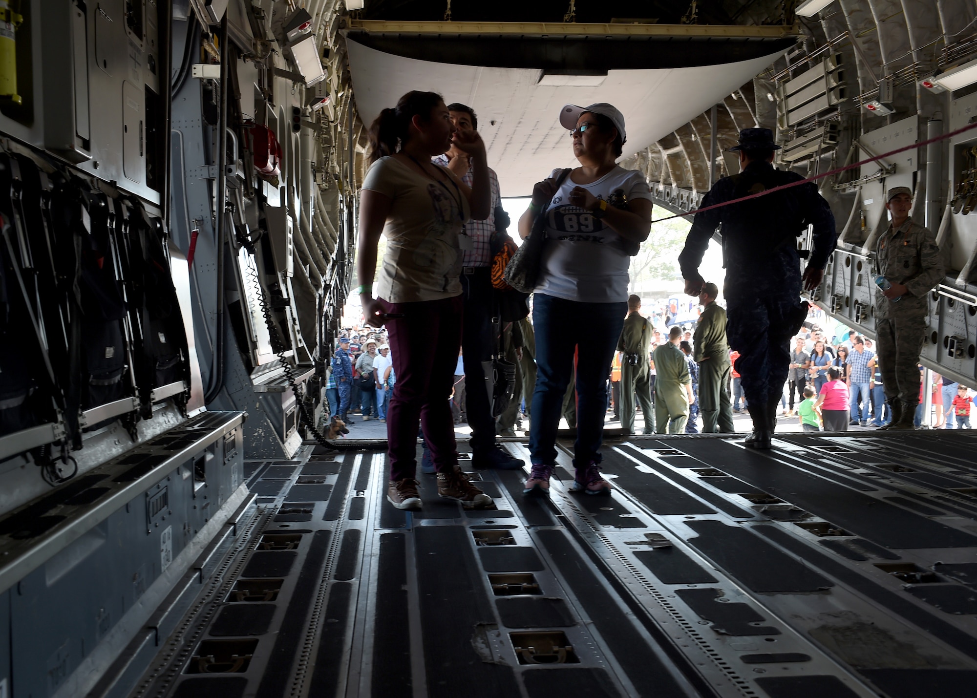 Citizens of El Salvador enter as a U.S. Air Force C-17 Globemaster III cargo aircraft, 58th Airlift Squadron at Ilopango International Airport in San Salvador, El Savador, Jan. 31, during the 2016 Ilopango Airshow. The C-17 was sent from Altus Air Force Base, Okla., to foster relationships between the U.S. and El Salvador. The aircraft was setup as a static display for the attendees to view and learn about some of its capabilities. (U.S. Air Force photo by Senior Airman Franklin R. Ramos/Released)