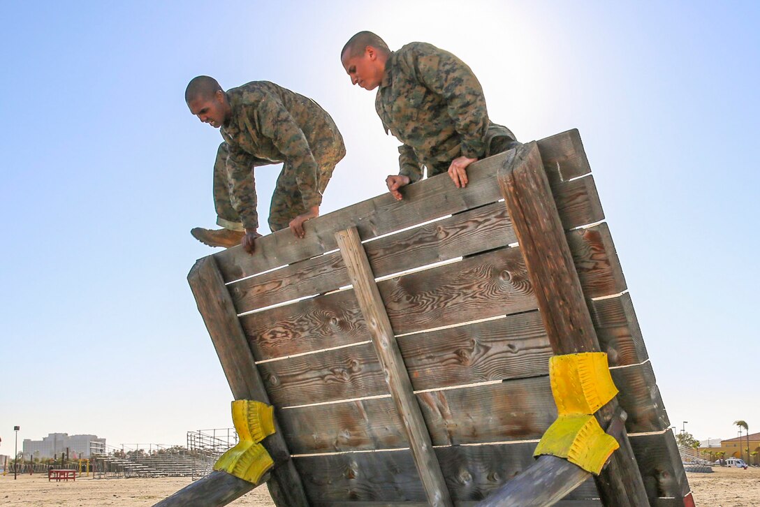 Marine Corps recruits climb over a wall at Marine Corps Recruit Depot San Diego, Jan. 25, 2016. Drill instructors monitored the recruits’ progress to make sure they were maneuvering over the obstacle correctly. Marine Corps photo by Lance Cpl. Angelica I. Annastas
