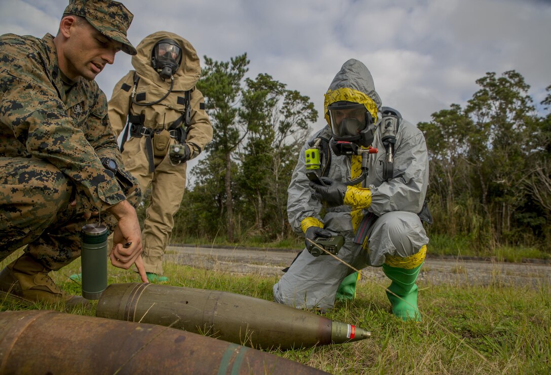 Staff Sgt. Jarret Garibaldi, left, instructs Staff Sgt. Cody Fazio on a 155 mm howitzer round during a joint-training exercise between III Marine Expeditionary Force Chemical, Biological, Radiological, Nuclear and Explosive Ordnance Disposal units at the Central Training Area, Camp Hansen, Okinawa, Japan, Jan. 29, 2016. The exercise enhances unit cohesion between the two units for further training, real-world instances and keeping the Asia-Pacific region safe from explosive ordnance and CBRN threats. Garibaldi is from Napa, California, and is an EOD technician with 3rd Ordnance Disposal Company, 9th Engineer Support Battalion, 3rd Marine Logistics Group, III MEF. Fazio, from Billings, Montana, is an EOD technician with 3rd Ordnance Disposal Company, 9th ESB, 3rd MLG, III MEF. (U.S. Marine Corps photo by Lance Cpl. Kelsey M. Dornfeld/ Released)