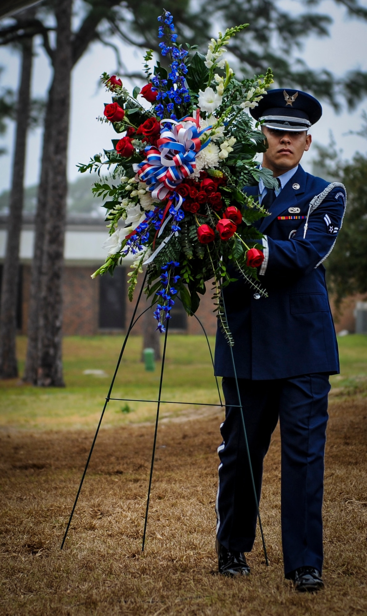Hurlburt Field Base Honor Guard member carries a wreath during a remembrance ceremony for Spirit 03 at Hurlburt Field, Fla., Feb. 2, 2016. Two days after the 25th anniversary, Air Commandos, friends and families gathered at the Air Park to honor the crew of the AC-130H Spectre gunship, shot down on the morning of Jan. 31, 1991, during the Battle of Khafji. (U.S. Air Force photo by Senior Airman Meagan Schutter)