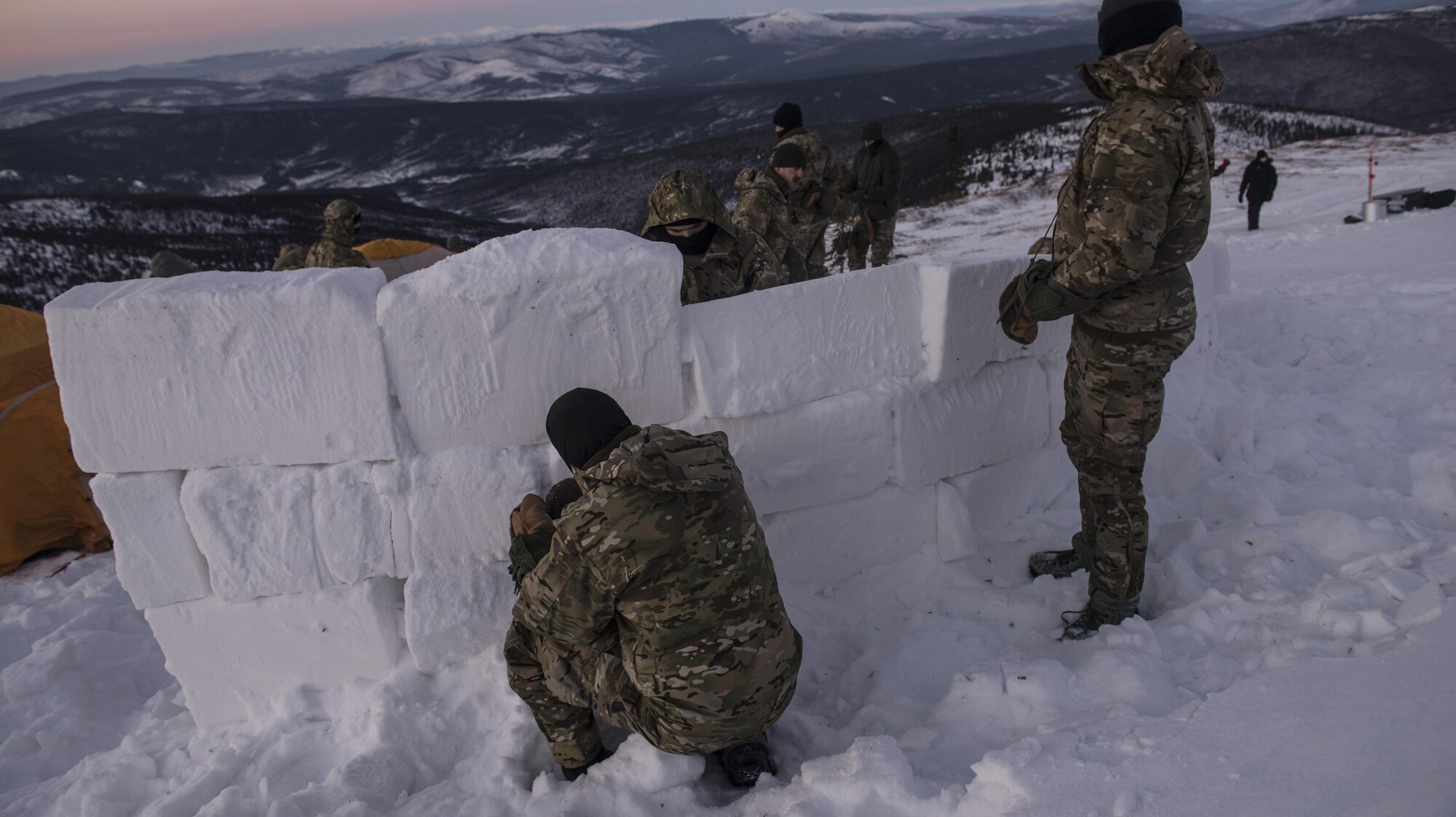 Students build a snow wall during Survival Evasion Resistance Escape (S.E.R.E) 5-level training Jan 20, 2016, in the Joint Pacific Alaska Range Complex. The Arctic survival training is a weeklong course that gives the S.E.R.E. specialist hands on experience with building shelters and surviving the extreme temperatures of the arctic. (U.S. Air Force photo by Staff Sgt. Joshua Turner/Released) 