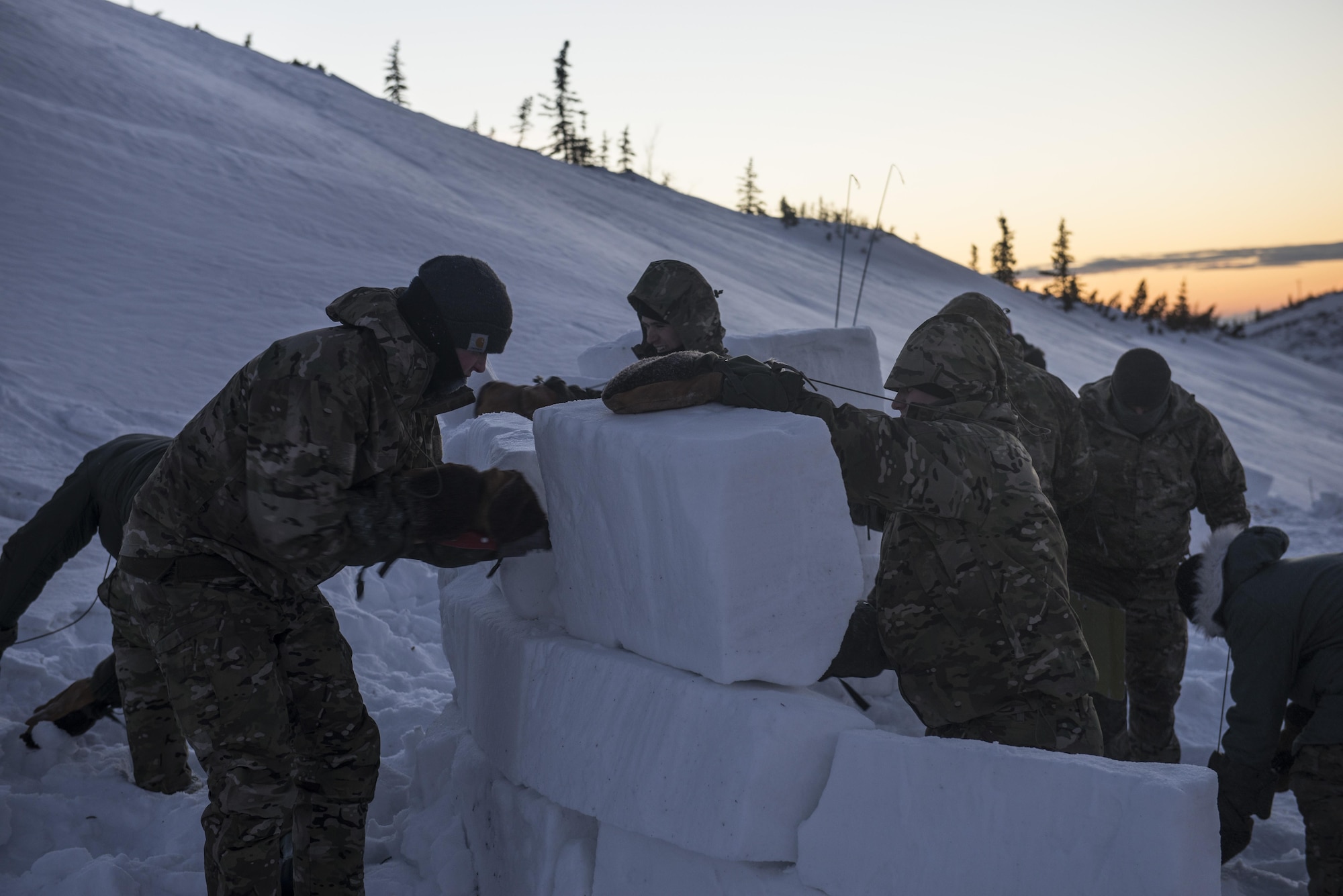 Students build a snow wall during Survival Evasion Resistance Escape (S.E.R.E) 5-level training Jan 20, 2016, in the Joint Pacific Alaska Range Complex. The Arctic survival training is a weeklong course that gives the S.E.R.E. specialist hands on experience with building shelters and surviving the extreme temperatures of the arctic. (U.S. Air Force photo by Staff Sgt. Joshua Turner/Released) 