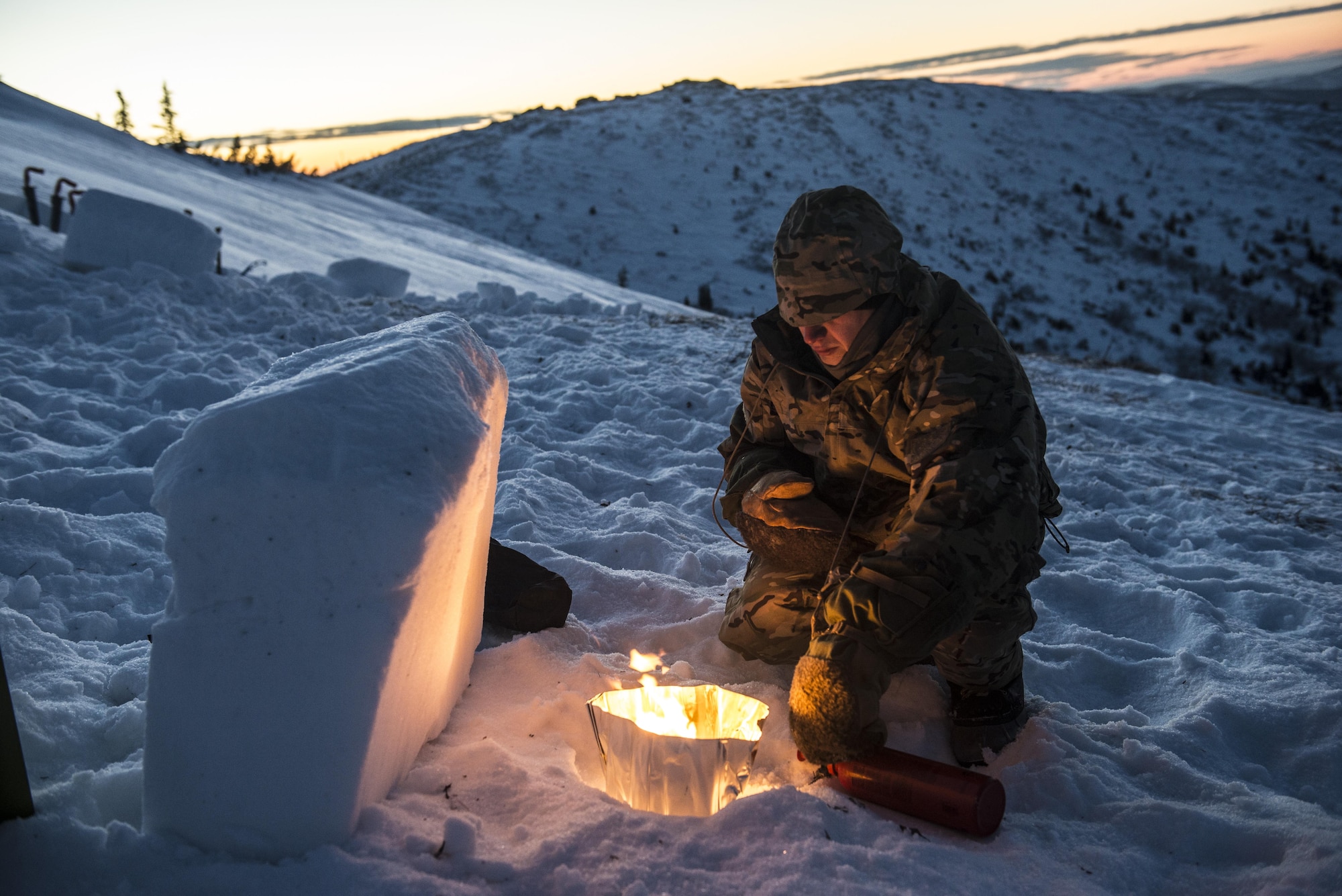 A Student prepares a burner during Survival Evasion Resistance Escape (S.E.R.E.) 5-level training Jan. 20, 2016, in the Joint Pacific Alaska Range Complex. The students had their own burners they used to melt chunks of snow for their water supply. (U.S. Air Force photo by Staff Sgt. Joshua Turner/Released)