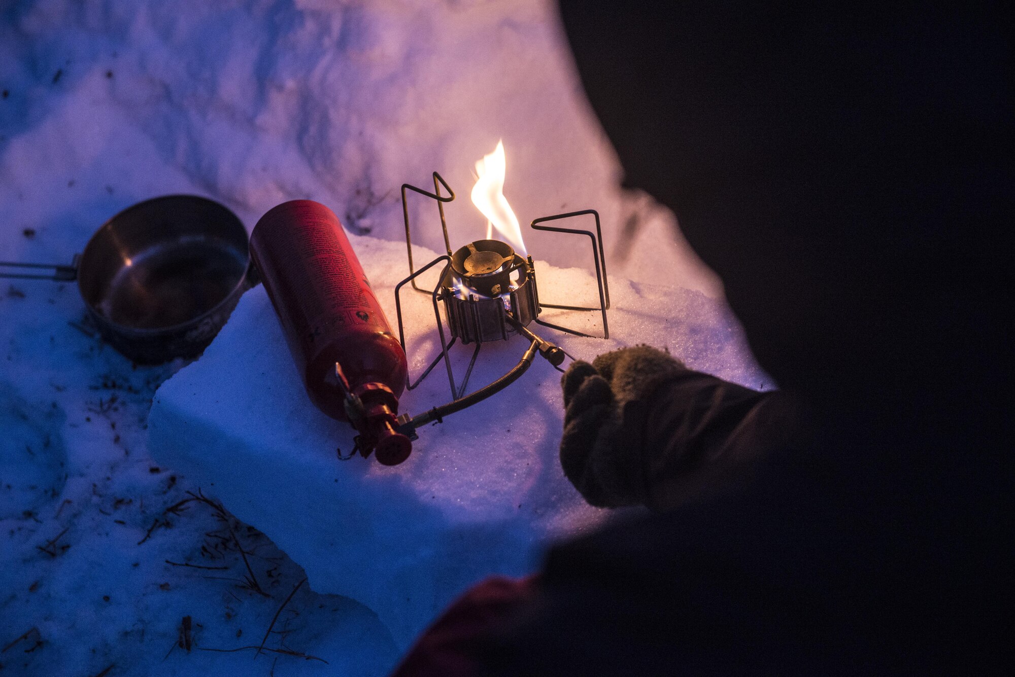 A Student prepares a burner during Survival Evasion Resistance Escape (S.E.R.E.) 5-level training Jan. 20, 2016, in the Joint Pacific Alaska Range Complex. The students had their own burners they used to melt chunks of snow for their water supply. (U.S. Air Force photo by Staff Sgt. Joshua Turner/Released)