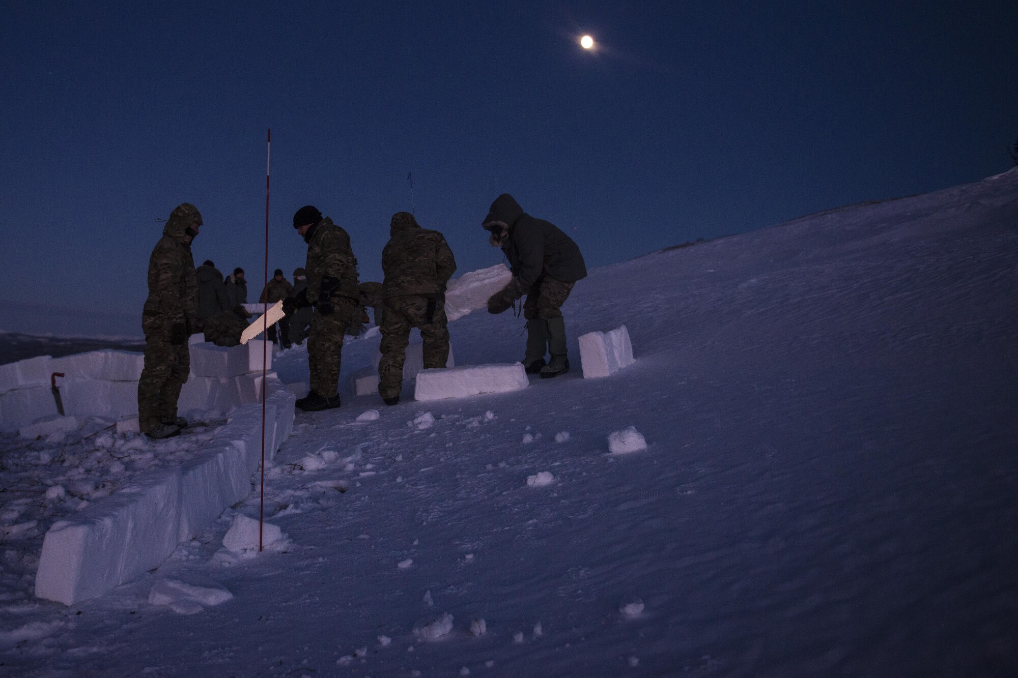 Students build a snow wall during Survival Evasion Resistance Escape (S.E.R.E) 5-level training Jan 20, 2016, in the Joint Pacific Alaska Range Complex. The Arctic survival training is a weeklong course that gives the S.E.R.E. specialist hands on experience with building shelters and surviving the extreme temperatures of the arctic. (U.S. Air Force photo by Staff Sgt. Joshua Turner/Released) 