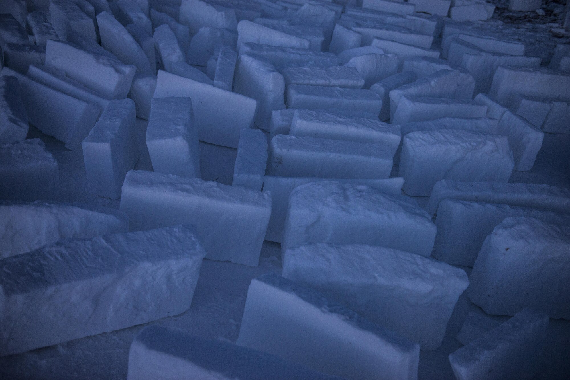 Dozens of snow blocks sit after being cut from packed snow during Survival Evasion Resistance Escape (S.E.R.E) 5-level training Jan 21, 2016, in the Joint Pacific Alaska Range Complex. The snow blocks were used to build a snow wall, igloos and other structures during the training. (U.S. Air Force photo by Staff Sgt. Joshua Turner/Released)