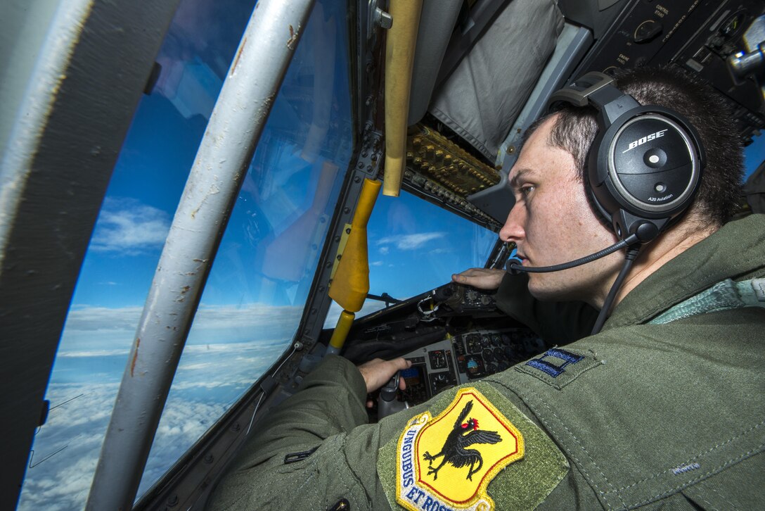 U.S. Air Force Capt. Christopher Thompson, 909th Air Refueling Squadron KC-135 Stratotanker pilot, scans the horizon for other aircraft during Forceful Tiger Jan. 28, 2016, near Okinawa, Japan. The 909th ARS, which is charged with supplying fuel to other aircraft in flight, delivered a total of 1.3 million pounds of fuel to more than 130 aircraft during the large force exercise. (U.S. Air Force photo by Staff Sgt. Maeson L. Elleman/Released)