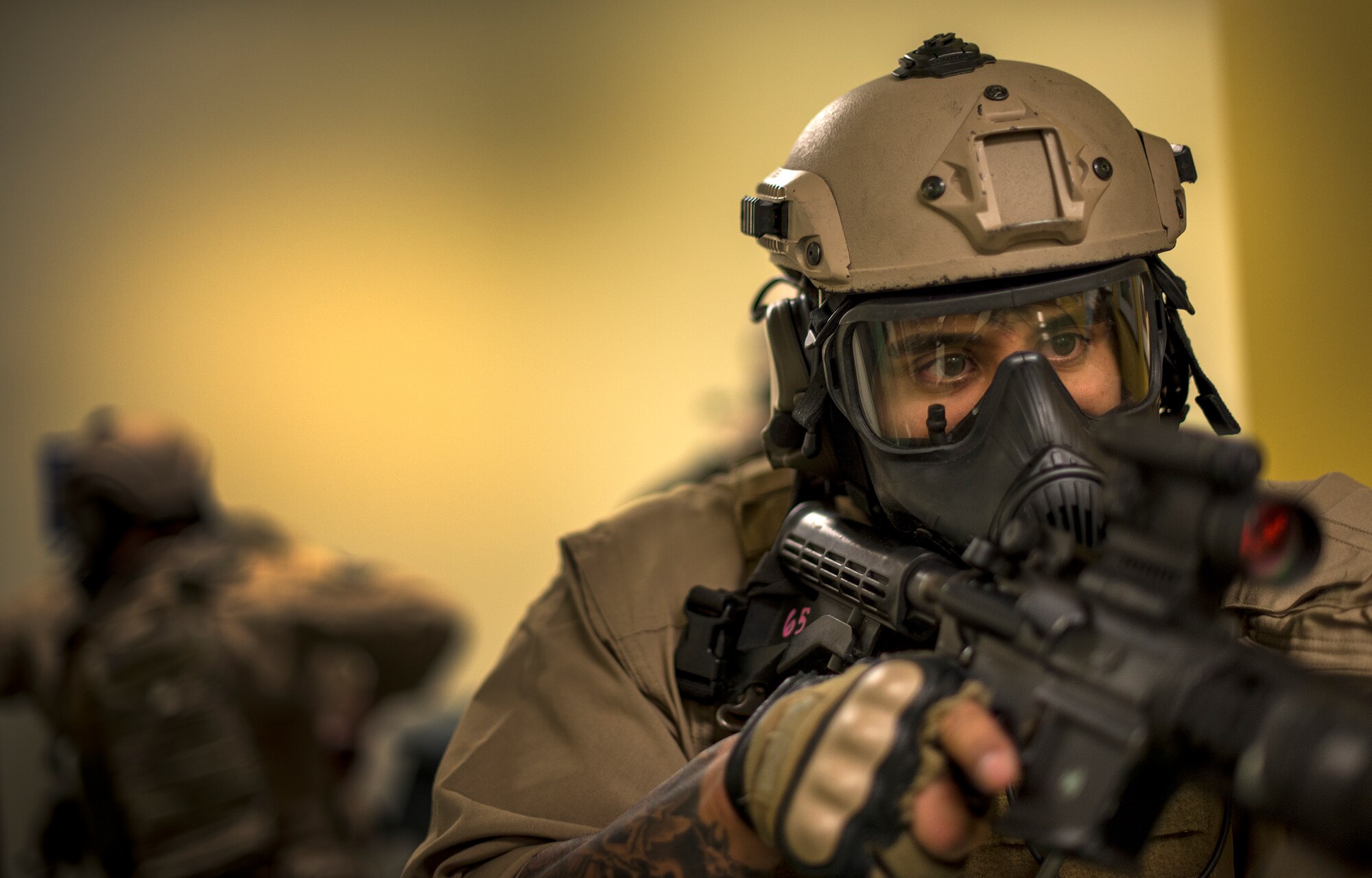 U.S. Air Force Staff Sgt. Israel Garza, 23d Security Forces Squadron unit trainer, secures a hallway as his team members clear a room at the youth center, Jan. 28, 2016, at Moody Air Force Base, Ga. Garza provided tips to improve clearing procedures during the SRT training and worked through scenarios as a member of the team. (U.S. Air Force photo by Tech. Sgt. Zachary Wolf/Released)