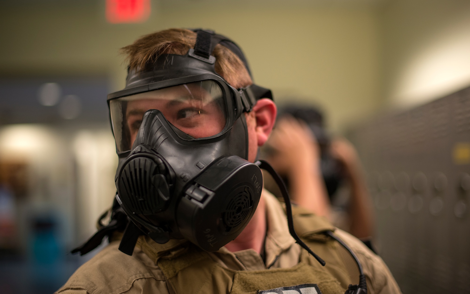 U.S. Air Force Staff Sgt. Andrew Morris, 23d Security Forces Squadron NCO in charge of combat arms, looks back at the team leader after donning his gas mask during Special Reaction Team training, Jan. 28, 2016 at Moody Air Force Base, Ga. The members of the SRT wore the gas masks to train for real-world scenarios. (U.S. Air Force photo by Tech. Sgt. Zachary Wolf/Released)
