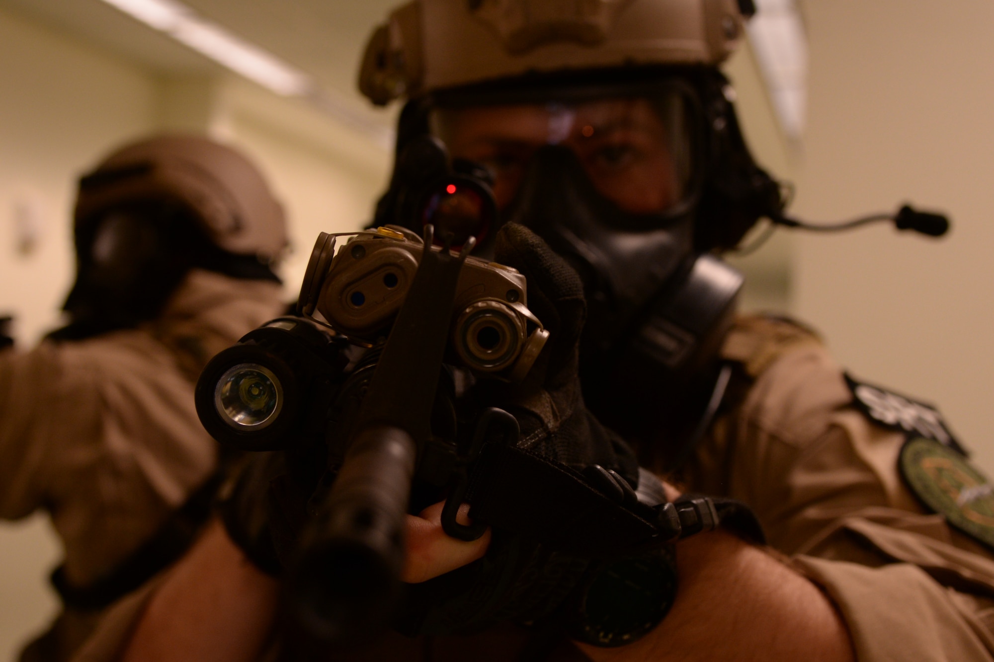 U.S. Air Force Staff Sgt. Andrew Morris, 23d Security Forces Squadron NCO in charge of combat arms, secures a hallway with his teammates during Special Reaction Team training, Jan. 28, 2016, at Moody Air Force Base, Ga. The SRT moves through hostile situations as one unit neutralizing threats and ensuring one another's safety. (U.S. Air Force photo by Airman 1st Class Janiqua P. Robinson/Released)