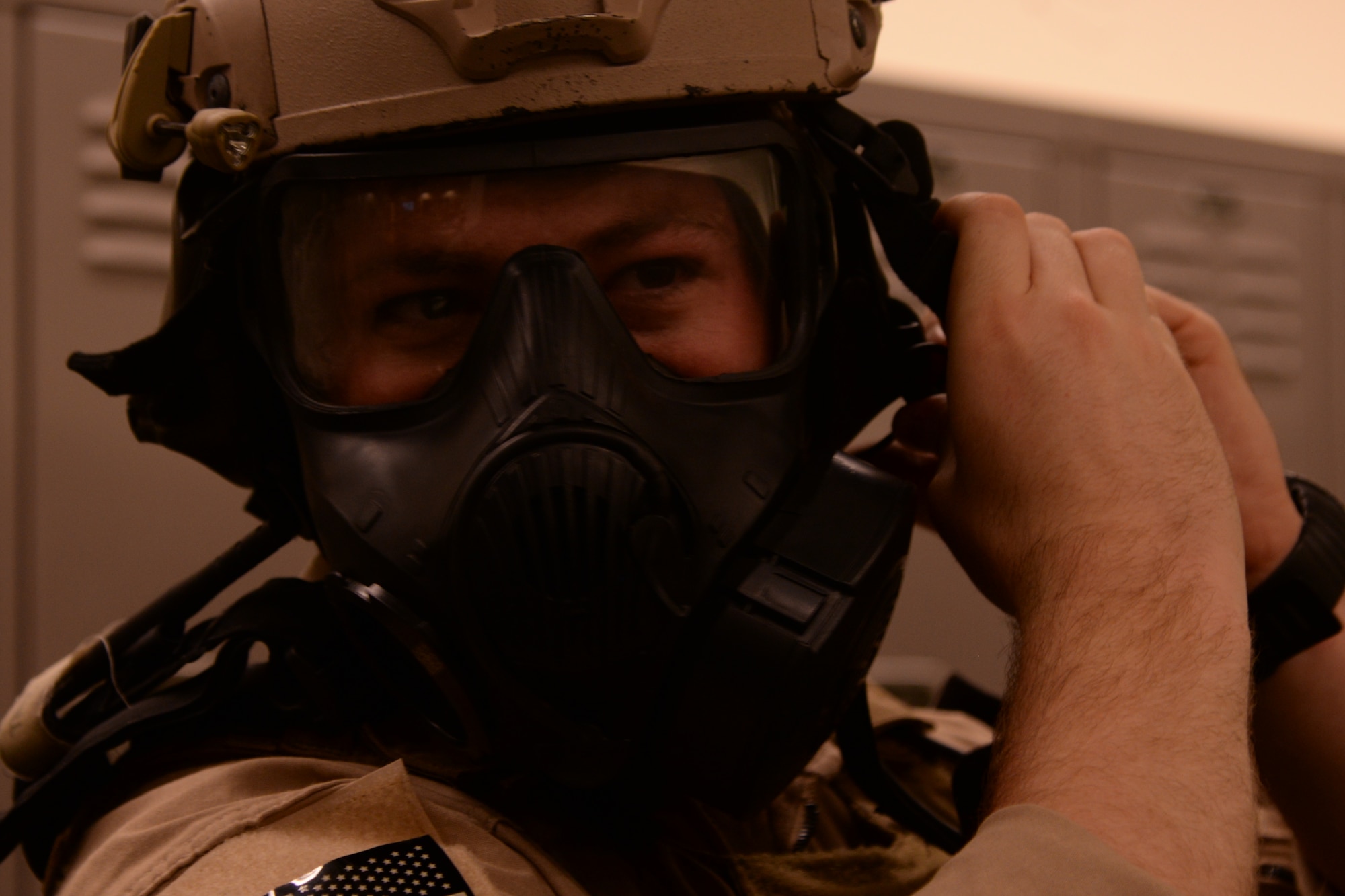 U.S. Air Force Staff Sgt. Andrew Morris, 23d Security Forces Squadron NCO in charge of combat arms, secures his gas mask and head gear during Special Reaction Team training, Jan. 28, 2016, at Moody Air Force Base, Ga. The SRT used gas masks to limit their visibility in order to test their capabilities. (U.S. Air Force photo by Airman 1st Class Janiqua P. Robinson/Released)