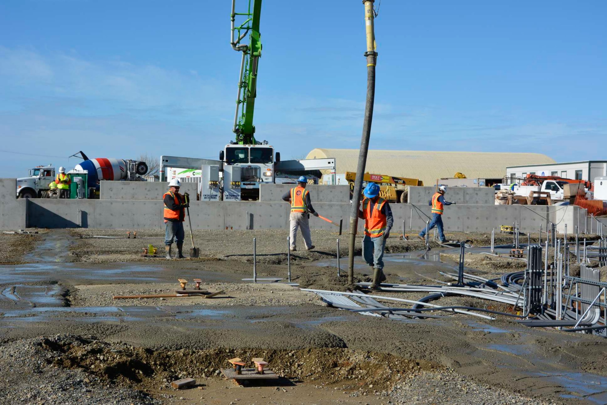 A construction crew pours concrete at the 548th Intelligence, Surveillance, and Reconnaissance Group’s Distribution Common Ground System project site Jan. 8, 2016, at Beale Air Force Base, California. The DCGS will work in conjunction with other ISR assets to meet the demand for time-critical processing, exploitation, and dissemination of actionable intelligence data in support of combat operations. They also have the ability to support contingencies worldwide and integrate new ISR technologies as they are operationally fielded. (U.S. Air Force photo by Sean Beermann)