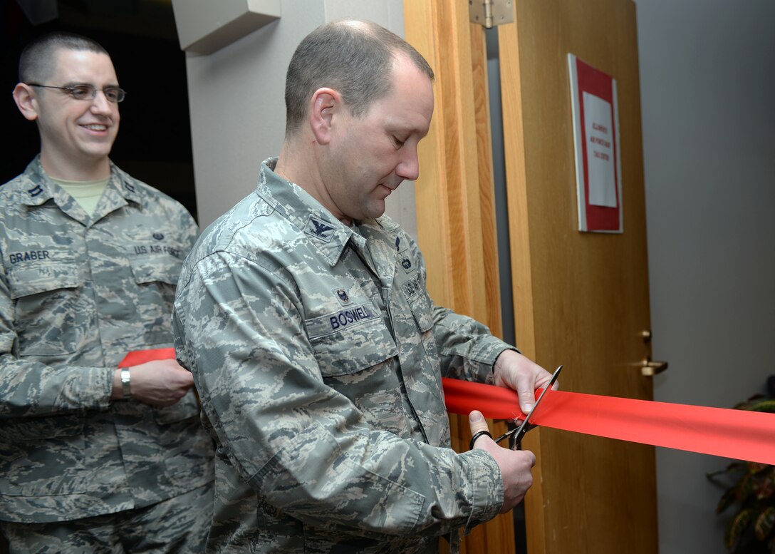 Col. Gentry Boswell, 28th Bomb Wing commander, cuts the ribbon during the 2016 Tax Center grand opening at Ellsworth Air Force Base, S.D., Jan. 28, 2016. The Tax Center is located in suite 1300 of the Rushmore Center – personnel will be assisted on an “appointment only” basis. (U.S. Air Force photo by Airman Donald Knechtel/Released)