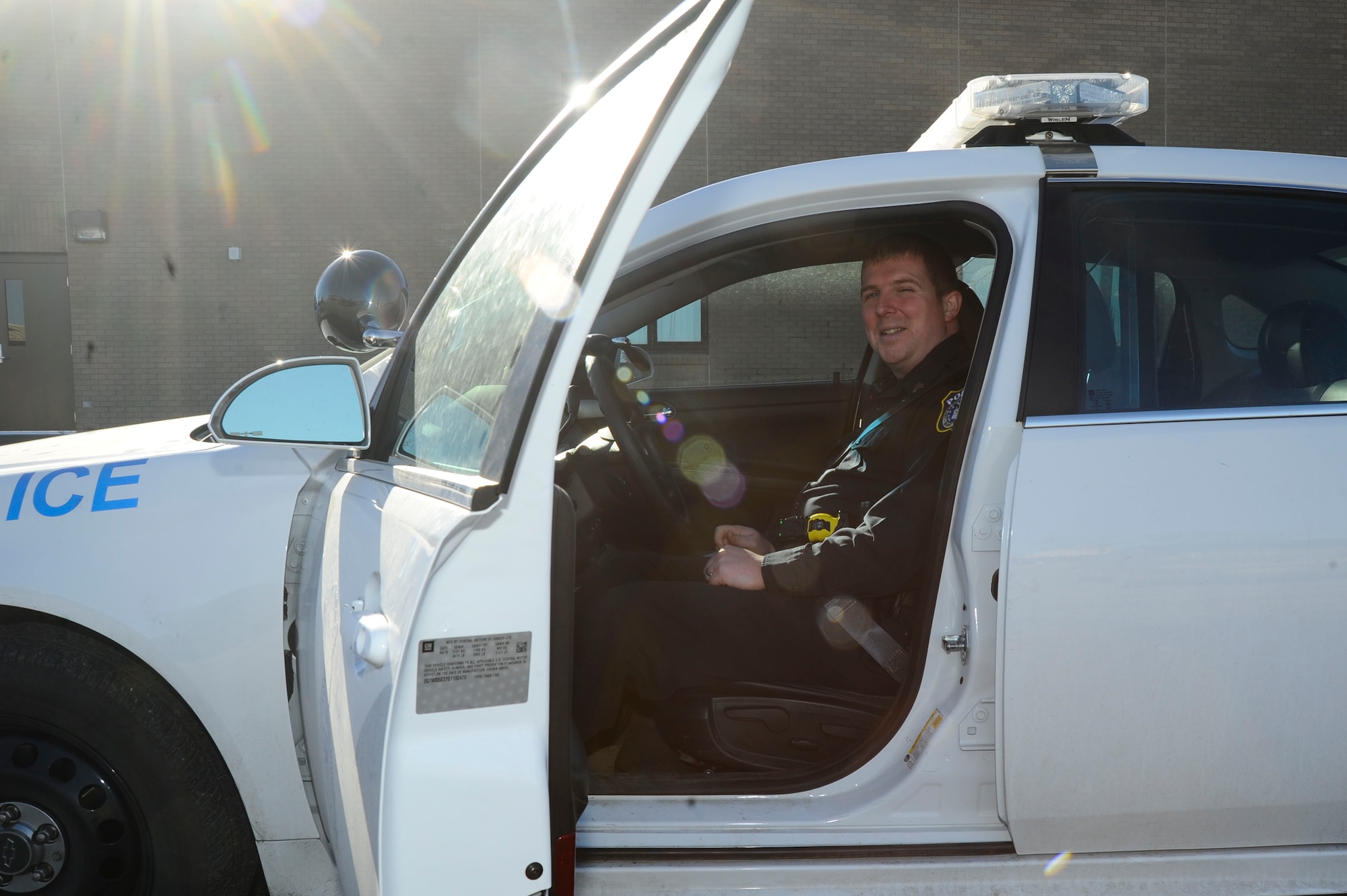 Shawn Kennedy, 22nd Security Forces Squadron supervisory police officer, poses for a photo in his squad car, Jan. 29, 2016, at McConnell Air Force Base, Kan. Kennedy received the Air Force Outstanding Security Forces Flight-Level Civilian Supervisory Level Award for excellent work within his career field, advancement in education and volunteer work within the local community (U.S. Air Force photo/Airman Jenna K. Caldwell) 