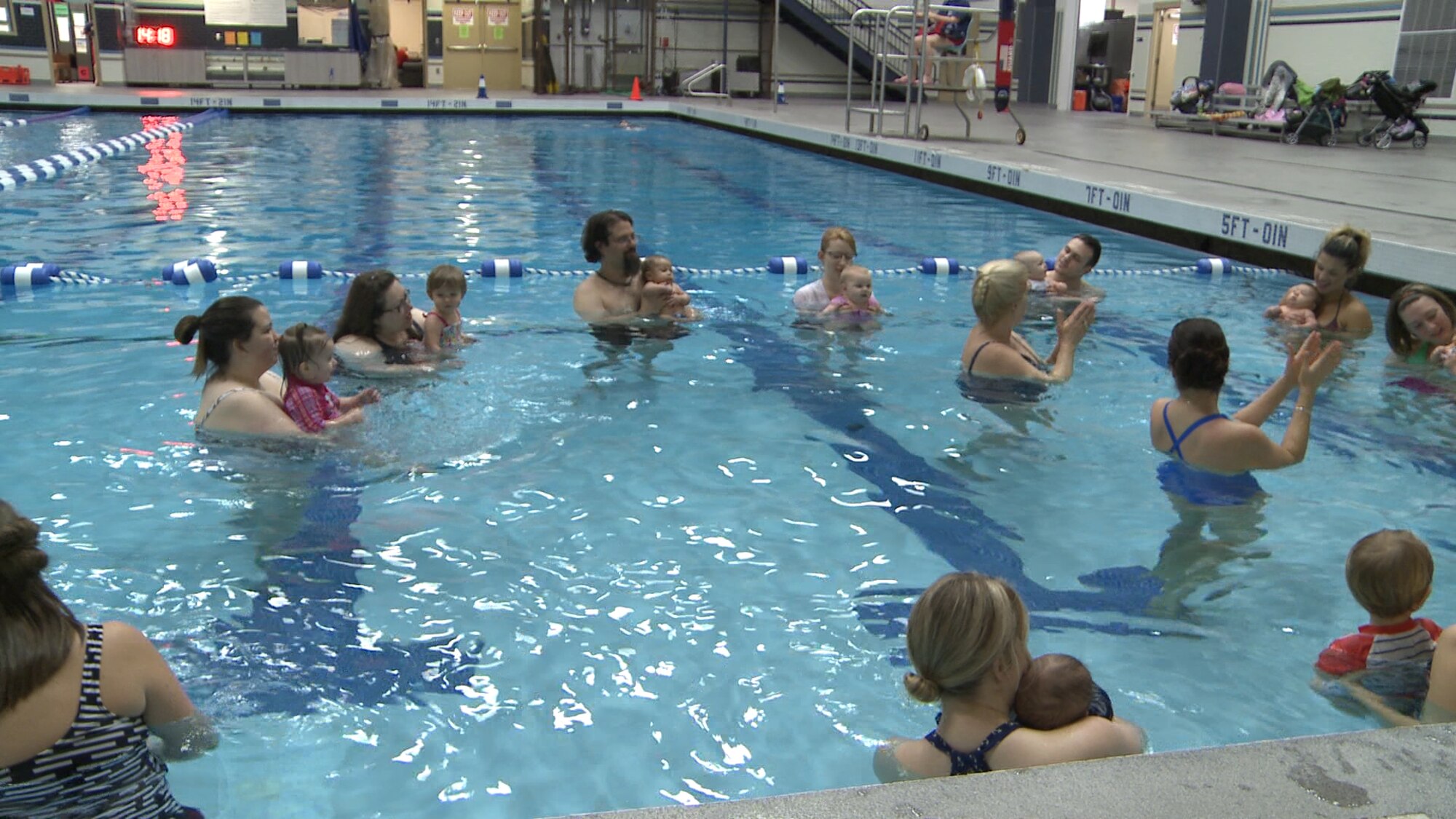 Mary (Puffett) Cook, 92nd Medical Group new parent support program nurse, and Susanna Senent, 92nd MDG Family Advocacy program assistant, coaches parents and children through a song during the Water Babies class January 27, 2016, in the Fitness Center at Fairchild Air Force Base, Wash. The class starts with singing and repetitive behavior for the kids. (U.S. Air Force photo/ Tech. Sgt. Monique Jose Duvall)