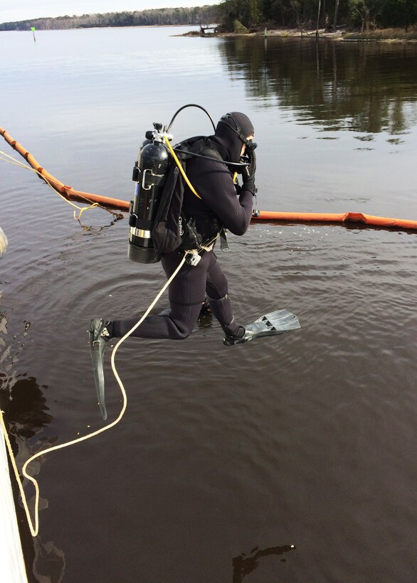 U.S. Army 1st Lt. Grant Rice, 511th Engineer Dive Detachment executive officer, executes a front-step water entry procedure at Marine Corps Air Station Cherry Point, N.C., Jan. 20, 2016. The detachment deployed 10 engineer divers to MCAS Cherry Point to conduct repairs on a 110-foot U.S. Coast Guard vessel taking on 9,000 gallons of water per day via a crack and holes in the hull, and a damaged propeller shaft tube. (Courtesy photo)