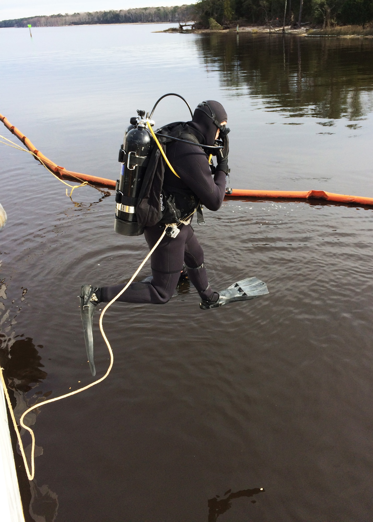 U.S. Army 1st Lt. Grant Rice, 511th Engineer Dive Detachment executive officer, executes a front-step water entry procedure at Marine Corps Air Station Cherry Point, N.C., Jan. 20, 2016. The detachment deployed 10 engineer divers to MCAS Cherry Point to conduct repairs on a 110-foot U.S. Coast Guard vessel taking on 9,000 gallons of water per day via a crack and holes in the hull, and a damaged propeller shaft tube. (Courtesy photo)