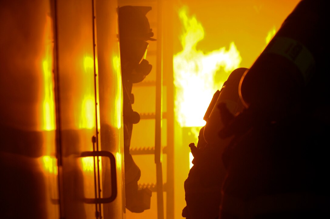U.S. Army Soldiers assigned to the Maritime Intermodal Training Department put out a fire in a simulator during live-fire training at Fort Eustis, Va., Jan. 28, 2016. The intensity of the fire and smoke is controlled to create a realistic and safe learning environment. (U.S. Air Force by Senior Airman Breonna Veal)