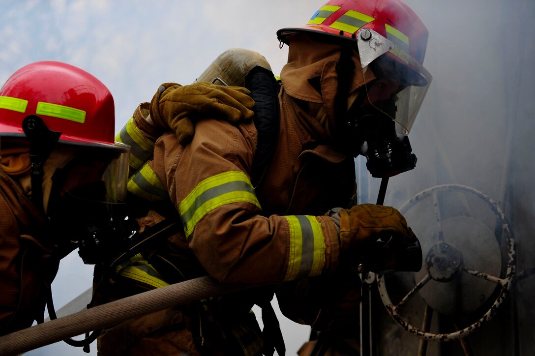U.S. Army Soldiers assigned to the Maritime Intermodal Training Department enter a burning simulator during live-fire training at Fort Eustis, Va., Jan. 28, 2016. The students had to successfully enter the simulator and use correct hosing techniques to put out the fire, thus creating the saying, “learn or burn.” (U.S. Air Force by Senior Airman Breonna Veal)