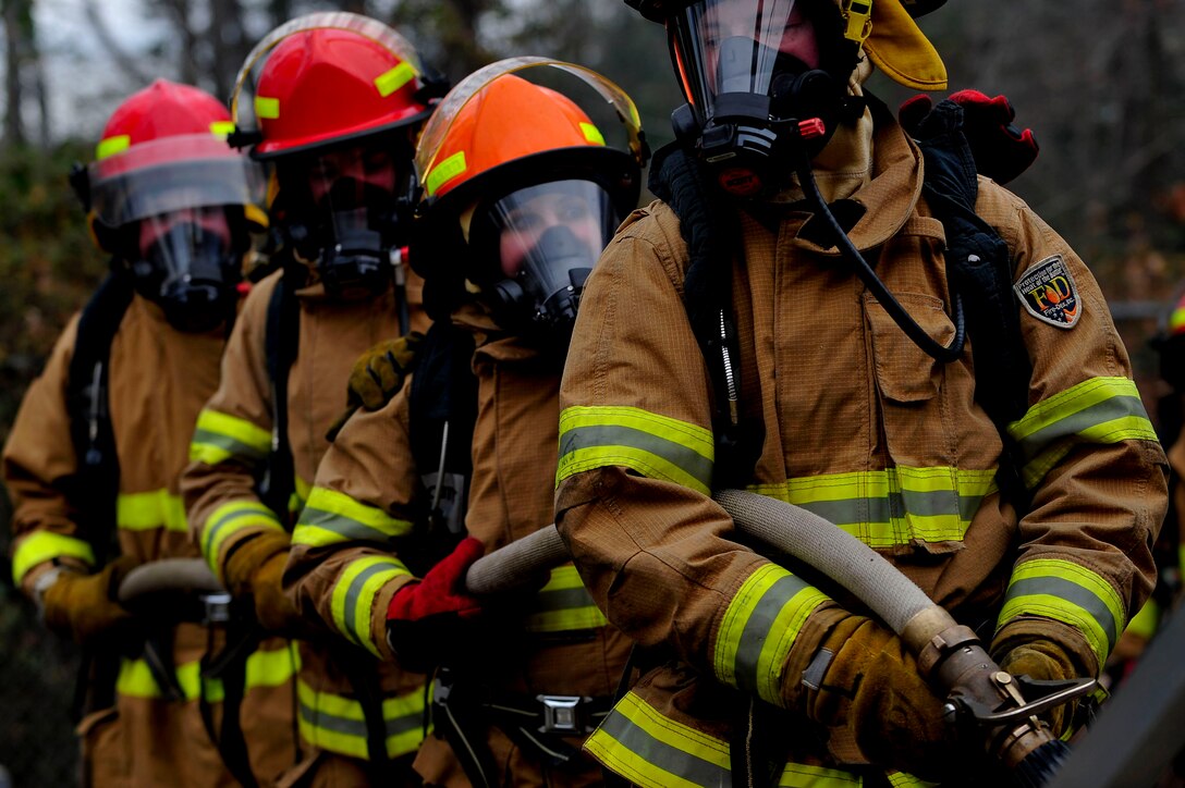U.S. Army Soldiers assigned to the Maritime Intermodal Training Department prepare to enter a burning simulator during live-fire training at Fort Eustis, Va., Jan. 28, 2016. Teams of three to four members went in to fight the fire in a simulated burning vessel. (U.S. Air Force by Senior Airman Breonna Veal)