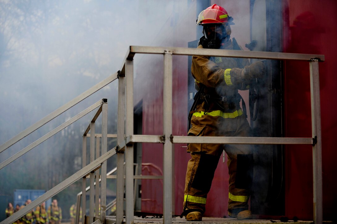 A U.S. Army Soldier assigned to the Maritime Intermodal Training Department opens the door to a fire simulator during class at Fort Eustis, Va., Jan. 28, 2016. The simulator reaches approximately 700 degrees Fahrenheit and burns using propane. (U.S. Air Force by Senior Airman Breonna Veal)