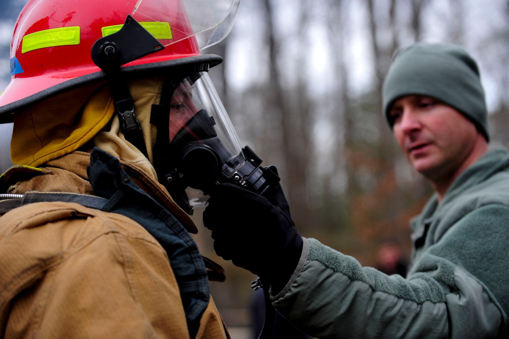 U.S. Army Sgt. First Class Dwayne Hysmith, Maritime Intermodal Training Department primary instructor, inspects a student’s gas mask before live-fire training at Fort Eustis, Va., Jan. 28, 2016. Instructors time the students’ ability to put the 30 pounds of gear on in two minutes or less. (U.S. Air Force by Senior Airman Breonna Veal)