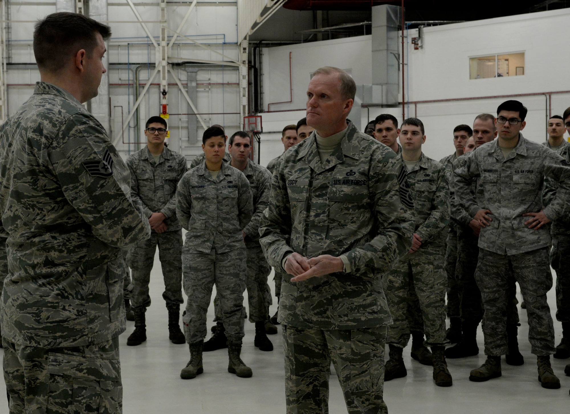 U.S. Air Force Staff Sgt. Ryan McAuley, 100th Maintenance Squadron fuel systems craftsmen, briefs Chief Master Sgt. of the Air Force James Cody on fuel cell capabilities Jan. 28, 2016, on RAF Mildenhall, England. Throughout his two-day visit, Cody spoke directly to Airmen, addressing their concerns and questions about the future of the Air Force. (U.S. Air Force photo by Senior Airman Victoria H. Taylor/Released)