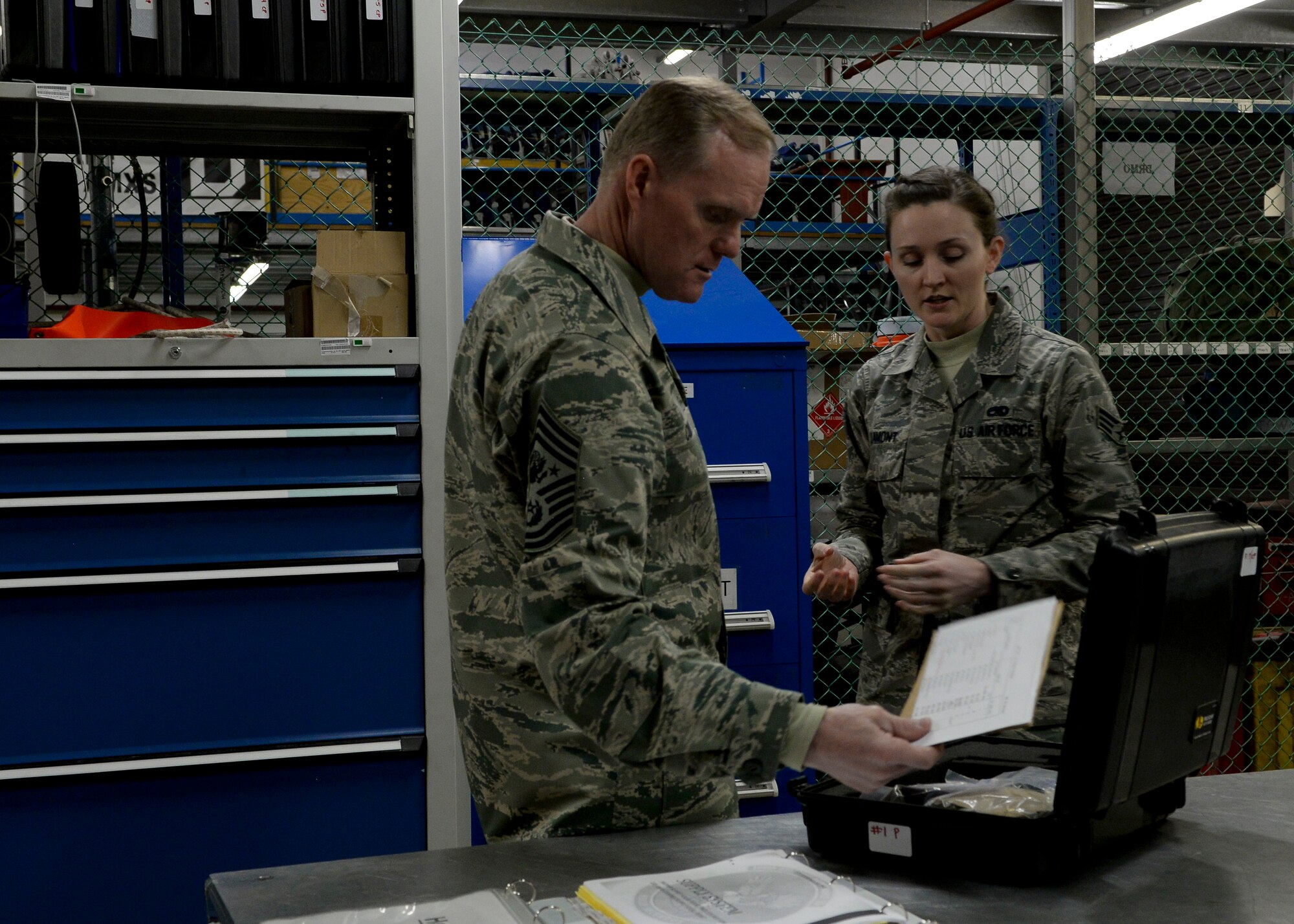 U.S. Air Force Senior Airman Ashley Lamont, 100th Aircraft Maintenance Squadron crew chief, shows Chief Master Sgt. of the Air Force James Cody a window replacement kit Jan. 28, 2016, on RAF Mildenhall, England. Cody met with Airmen from multiple units during his visit including the 352nd Special Operations Wing, the 95th Reconnaissance Squadron and the 488th Intelligence Squadron. (U.S. Air Force photo by Senior Airman Victoria H. Taylor/Released)