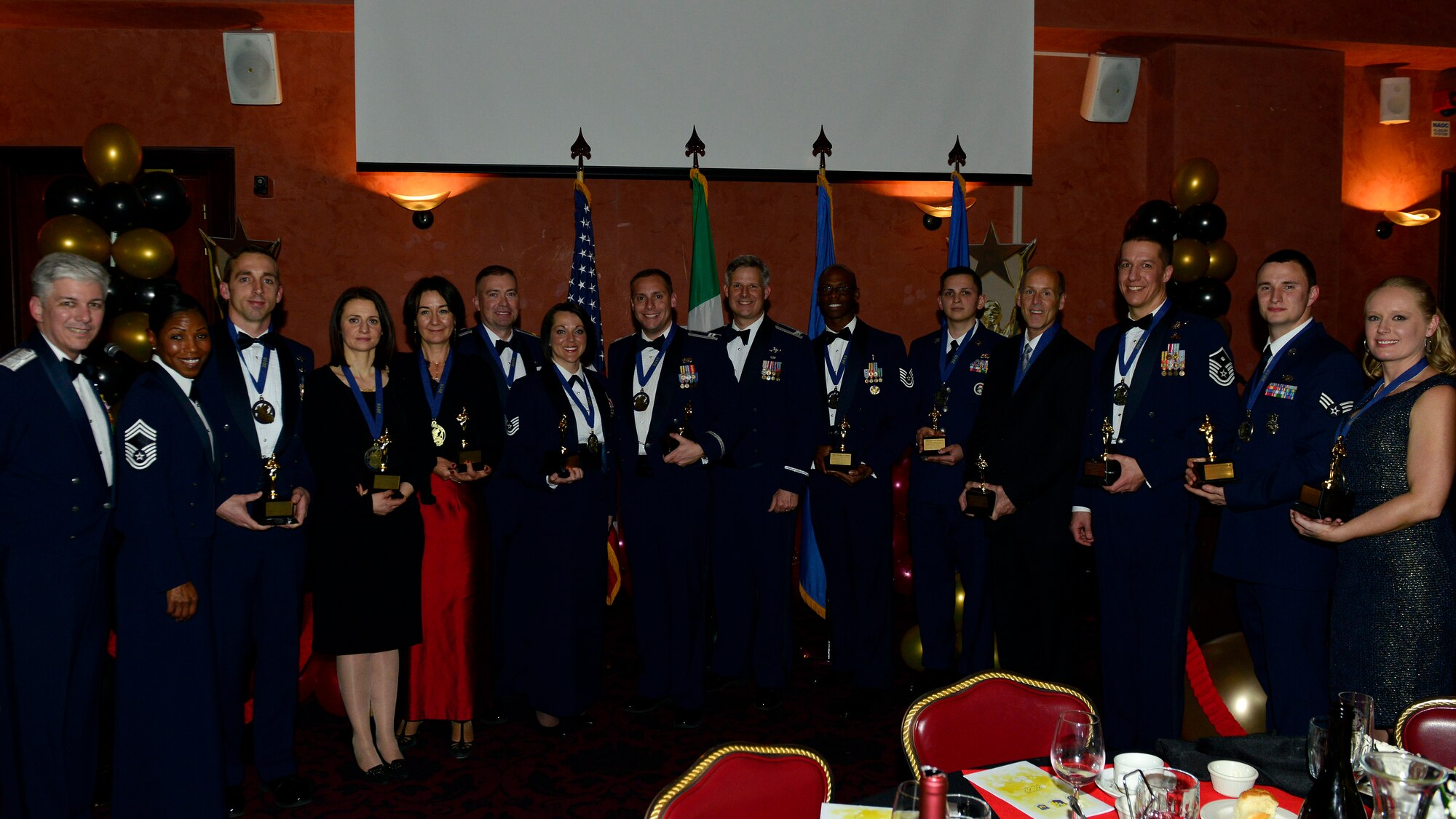 The 2015 31st Fighter Wing Annual Award winners pose with wing leaders at Aviano Air Base, Italy, Jan. 29, 2016. More than 200 Team Aviano members attended the awards ceremony, honoring the nominees for their dedication to the 31st FW mission in 2015. (U.S. Air Force photo/Airman 1st Class Cary Smith/Released)
