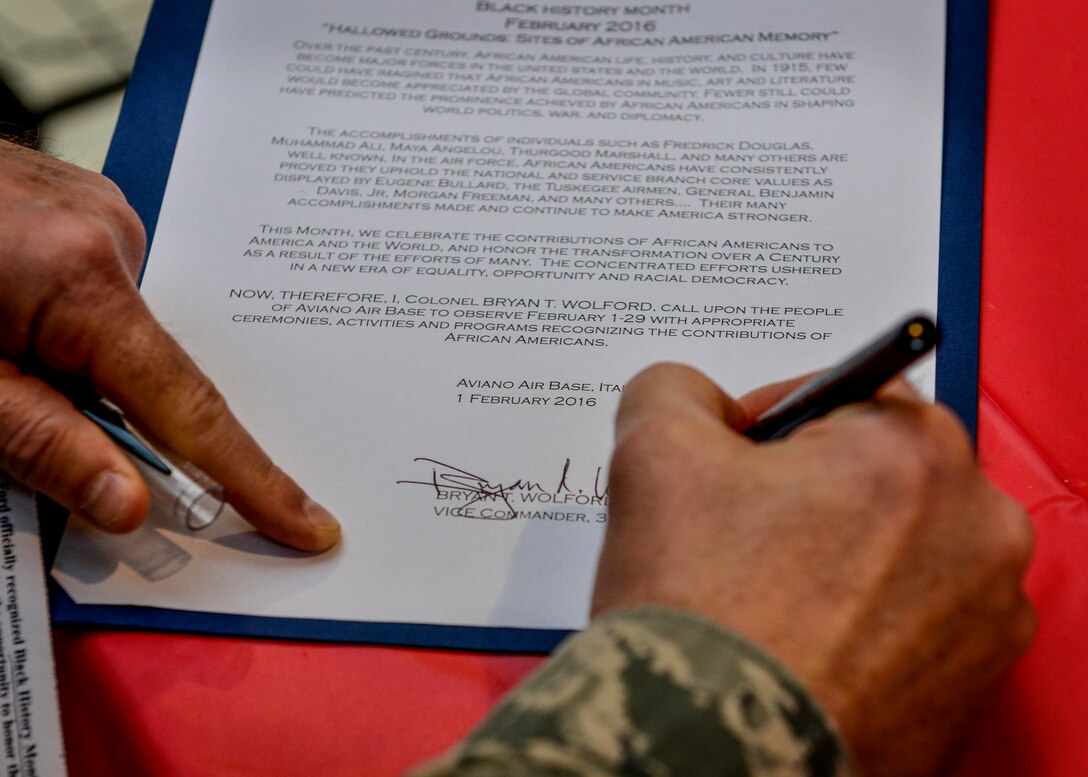U.S. Air Force Col. Bryan Wolford, 31st Fighter Wing vice commander, signs the African-American History Month proclamation at Aviano Air Base, Italy, Feb. 1, 2016. The next AAHM event is a luncheon Feb. 18 at 11 a.m. at the La Bella Vista Club. (U.S. Air Force photo by Airman 1st Class Cory W. Bush/Released)