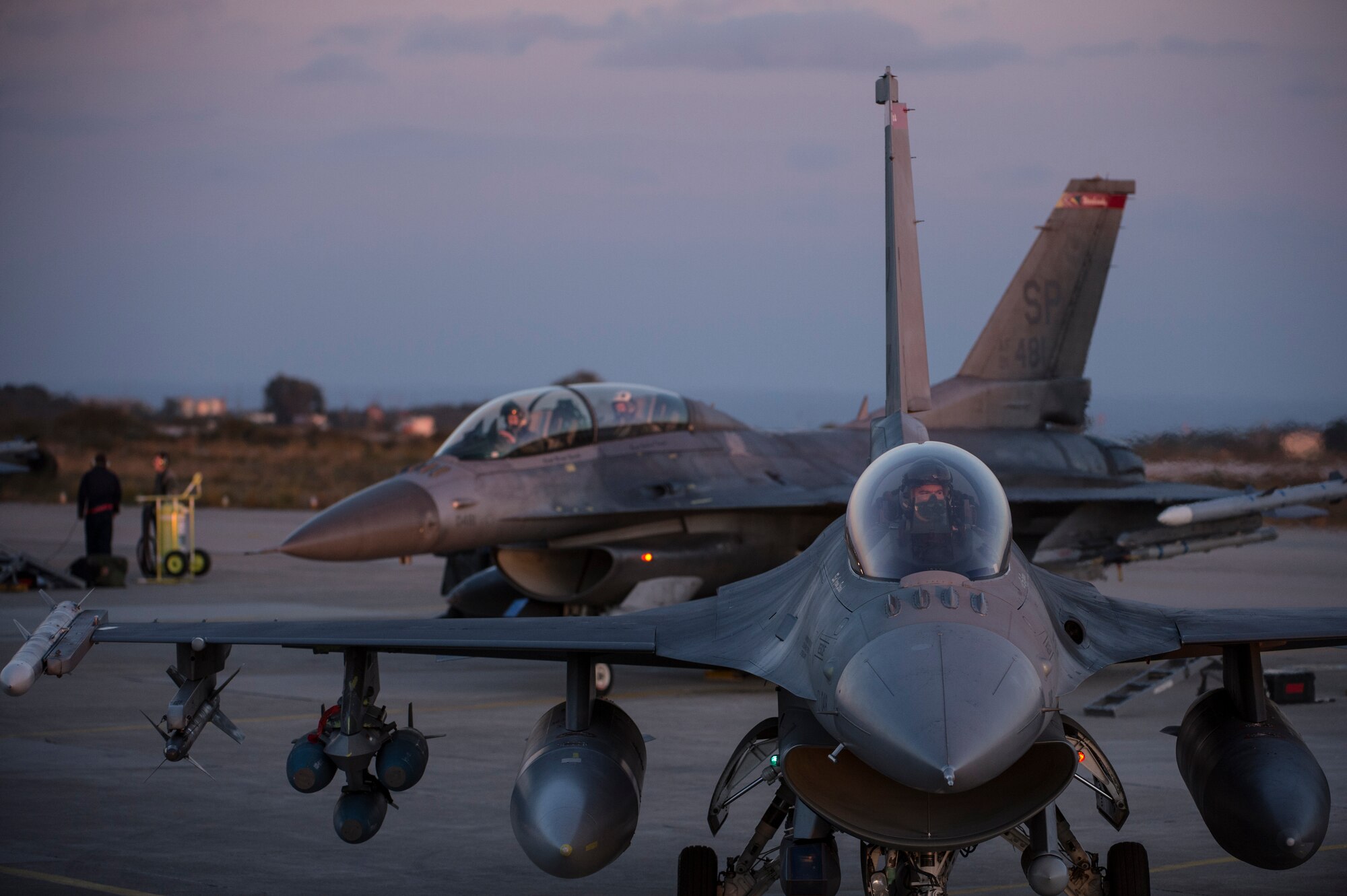 U.S. Air Force pilots from the 480th Expeditionary Fighter Squadron taxi F-16 Fighting Falcon fighter aircraft down the runway during a flying training deployment at Souda Bay, Greece, Feb. 1, 2016. The training took place on the northwest bay of Crete, alongside the island's White Mountain range and over the Mediterranean Sea. (U.S. Air Force photo by Staff Sgt. Christopher Ruano/Released)