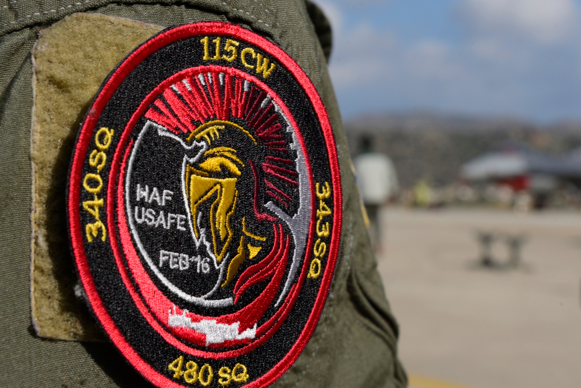 A commemorative patch hangs on an 480th Expeditionary Fighter Squadron pilots shoulder at Souda Bay, Greece, Feb. 1, 2016. The patch commemorates a flying training deployment between the U.S. Air Force's 480th EFS and the Hellenic air force's 115th Combat Wing held on the island of Crete Feb. 22-Feb 15, 2016. (U.S. Air Force photo by Staff Sgt. Christopher Ruano/Released)
