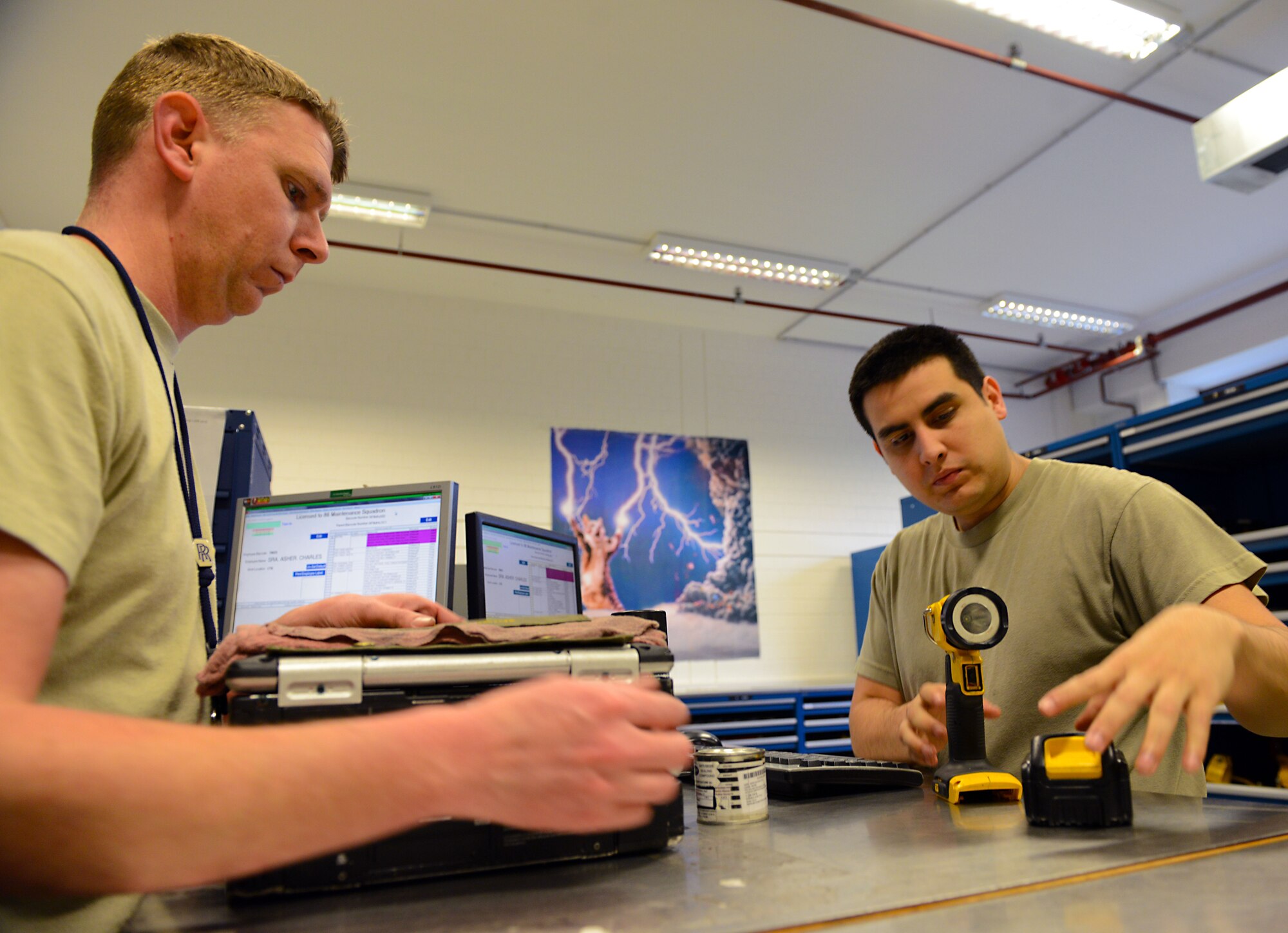Staff Sgt. Mark Fridel, right, 86th Maintenance Squadron crew chief, accepts tools from Staff Sgt. Joshua Stites, 86th MXS aerospace propulsion journeyman, at the end of their shift Jan. 13, 2016, at Ramstein Air Base, Germany. Tool accountability is important as it not only keeps track of tools used to fix the aircraft but also ensures those tools are not in a place that may cause damage to the aircraft. (U.S. Air Force photo/Staff Sgt. Timothy Moore)