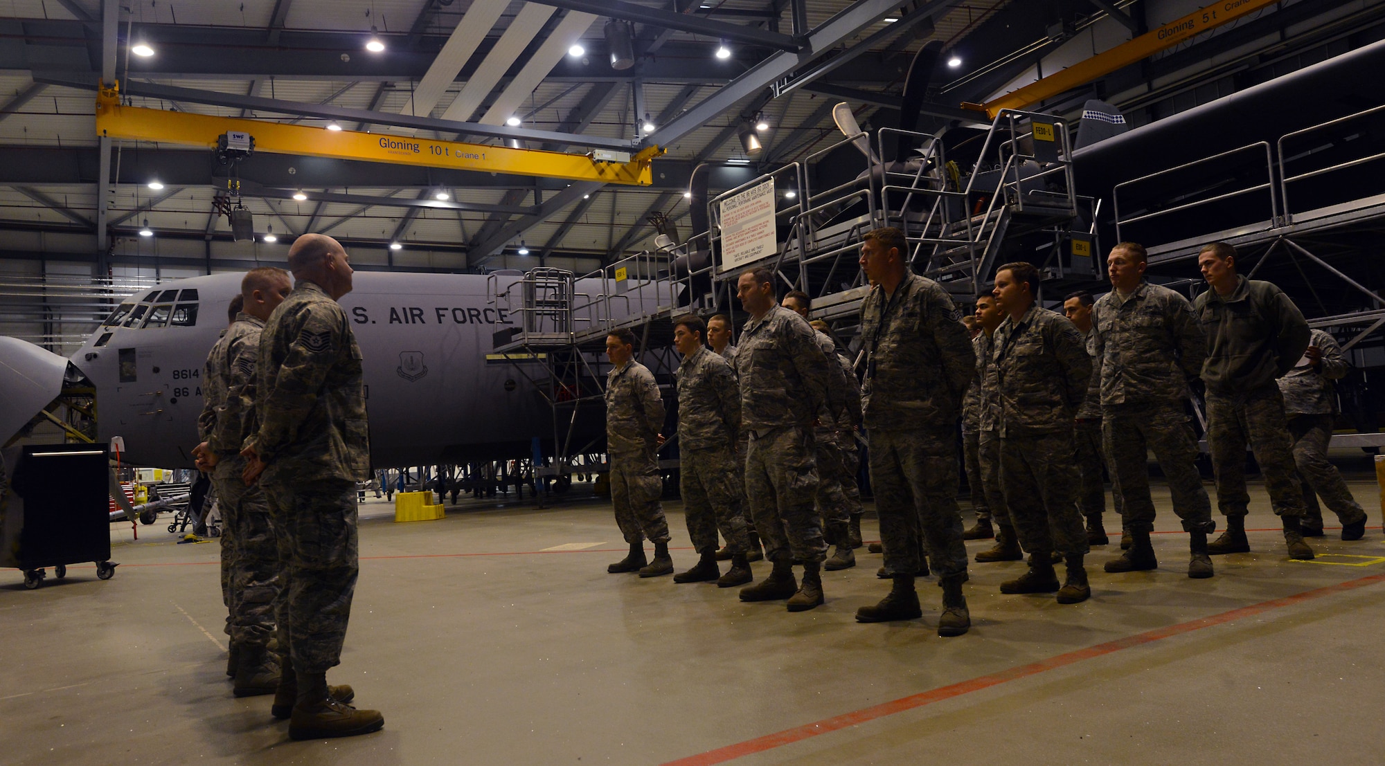 Airmen from the 86th Maintenance Squadron Isochronal (ISO) Inspection section stand in for the morning roll call Jan. 7, 2016, at Ramstein Air Base, Germany. The 86th MXS ISO inspection team was preparing to begin the day’s portion of a C-2 ISO inspection. A C-2 ISO inspection can take approximately two weeks to complete, depending on the maintenance required. (U.S. Air Force photo/Staff Sgt. Timothy Moore)