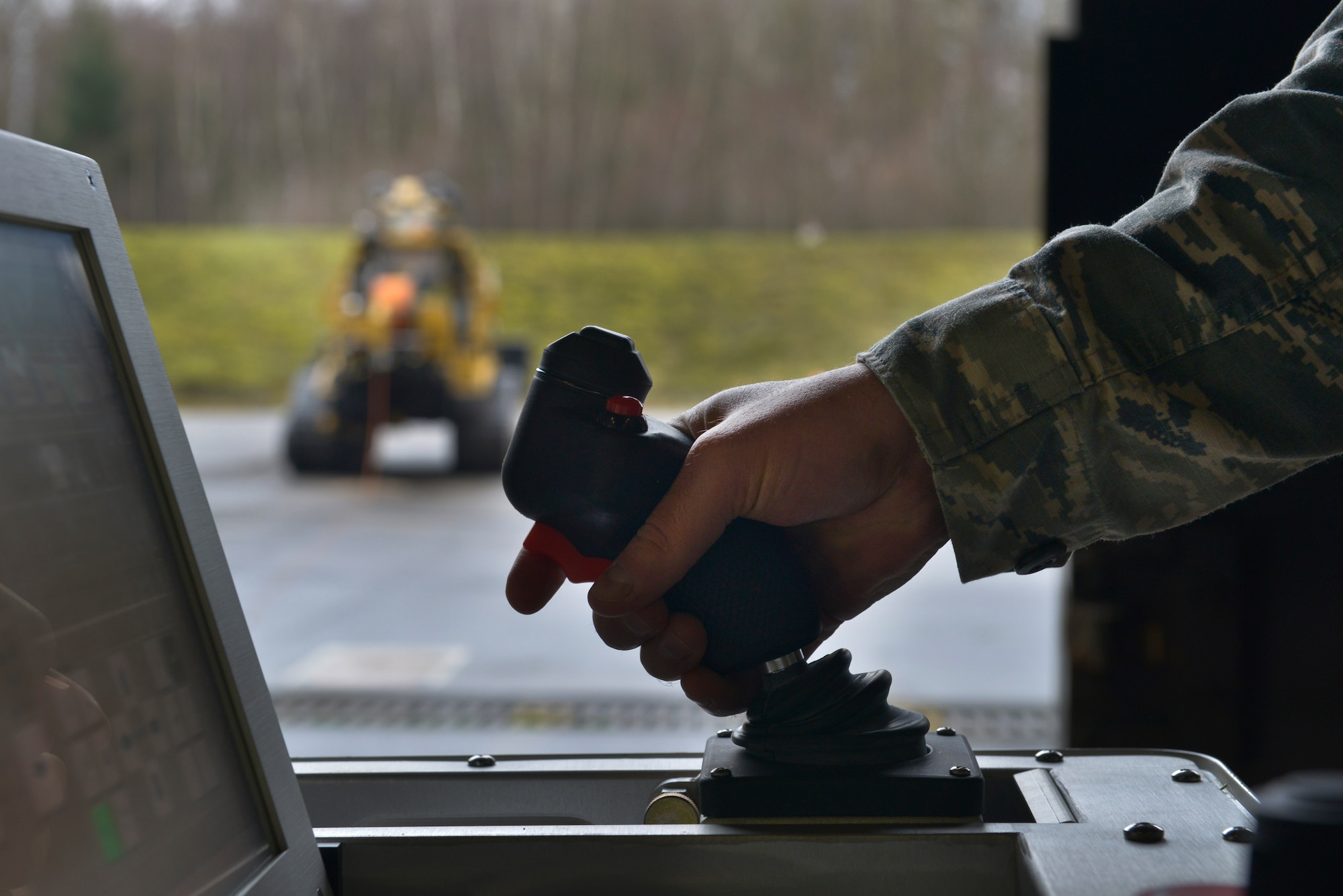 A technician from the 786th Civil Engineer Squadron Explosive Ordnance Disposal prepares the All-purpose Remote Transport System to begin testing Jan. 28, 2016, at Ramstein Air Base, Germany. The ARTS was tested on how it would perform in locating and picking up explosive hazards while keeping the Airmen controlling it safe at a distance. (U.S. Air Force photo/Airman 1st Class Lane T. Plummer)