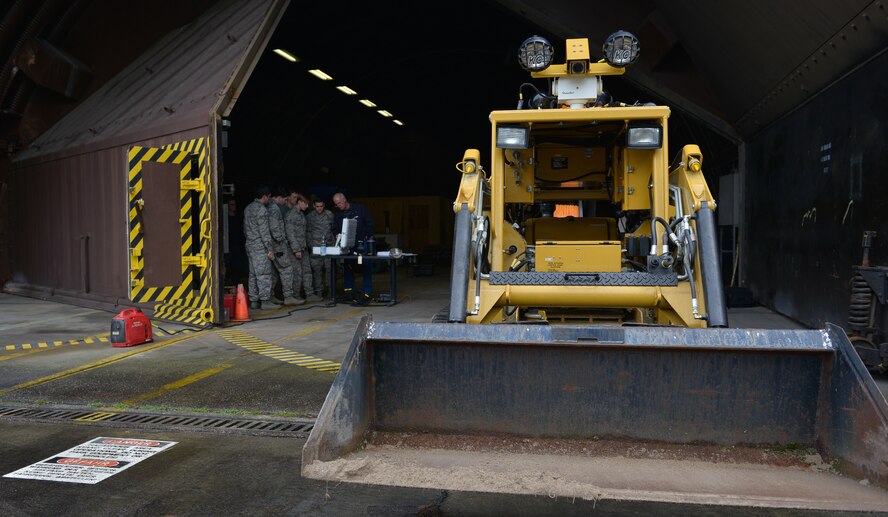 Airmen from the 786th Civil Engineer Squadron Explosive Ordnance Disposal configure their remote computer as they prepare to do maintenance on their All-purpose Remote Transport System Jan. 28, 2016, at Ramstein Air Base, Germany. The Airmen tested the ARTS on maneuvering through an environment and locating objects scattered around the training area. (U.S. Air force photo/Airman 1st Class Lane T. Plummer)