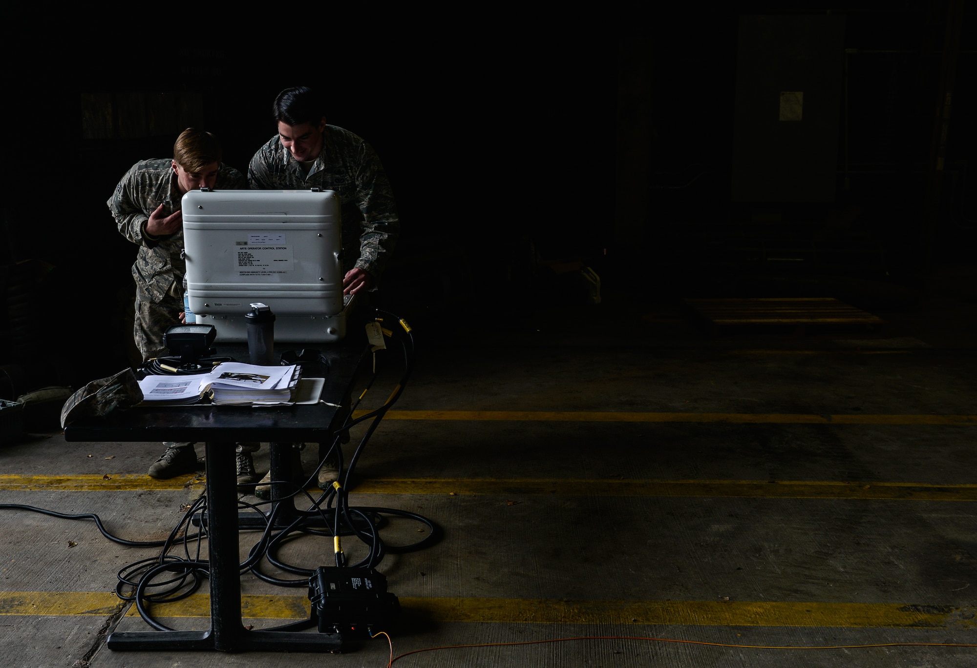 Senior Airman Jeffrey Knelange and Airman 1st Class Kevin Leyden, both 786th Civil Engineer Squadron Explosive Ordnance Disposal technicians, navigate a remote-controlled EOD vehicle Jan. 28, 2016, at Ramstein Air Base, Germany. The vehicle, an All-purpose Remote Transport System, is a 3.5-ton vehicle that is can be used as several different tools such as a forklift or an unexploded ordnance clearance vehicle. (U.S. Air Force photo/Airman 1st Class Lane T. Plummer)
